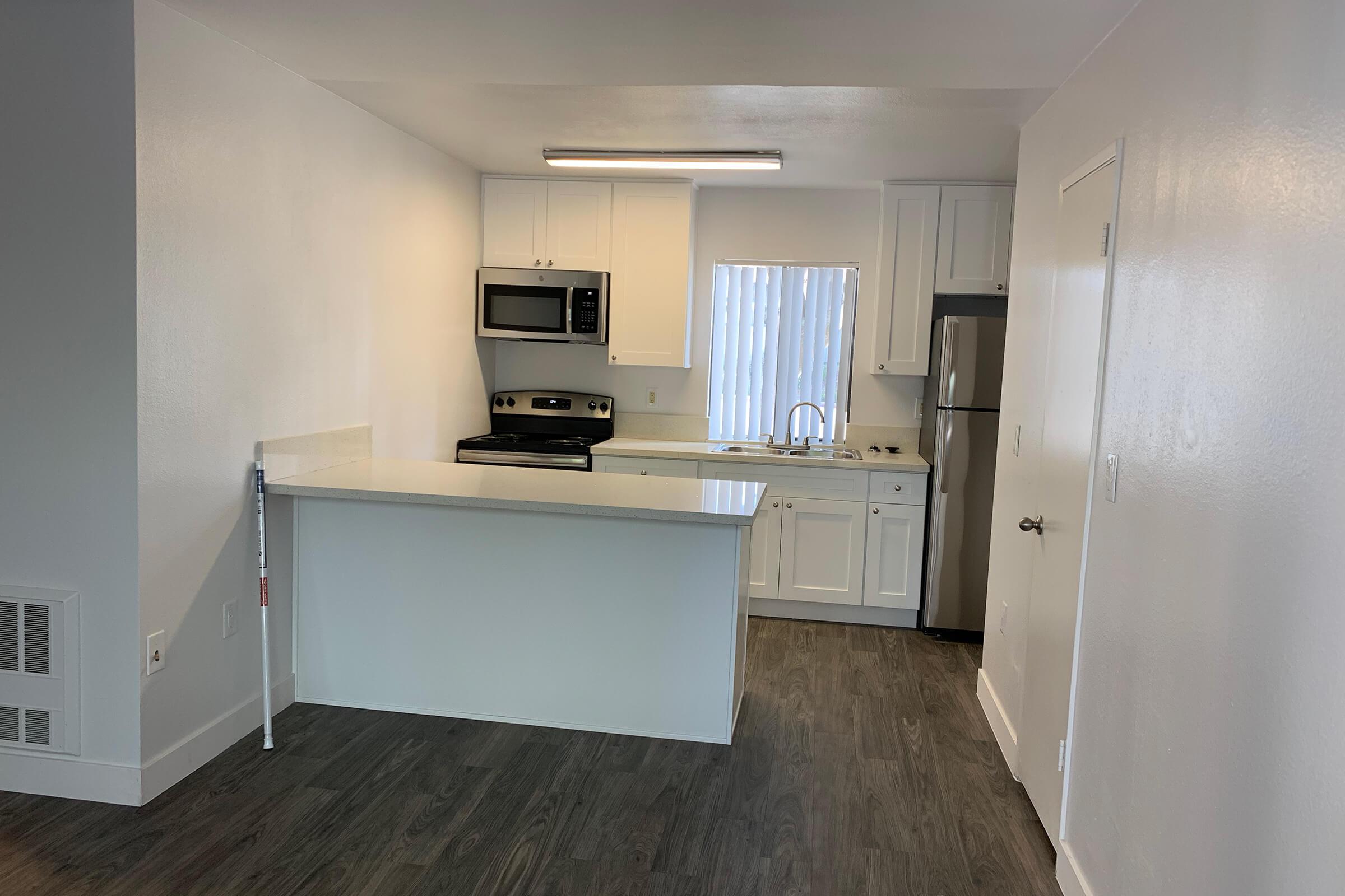 a kitchen with a stove and a refrigerator