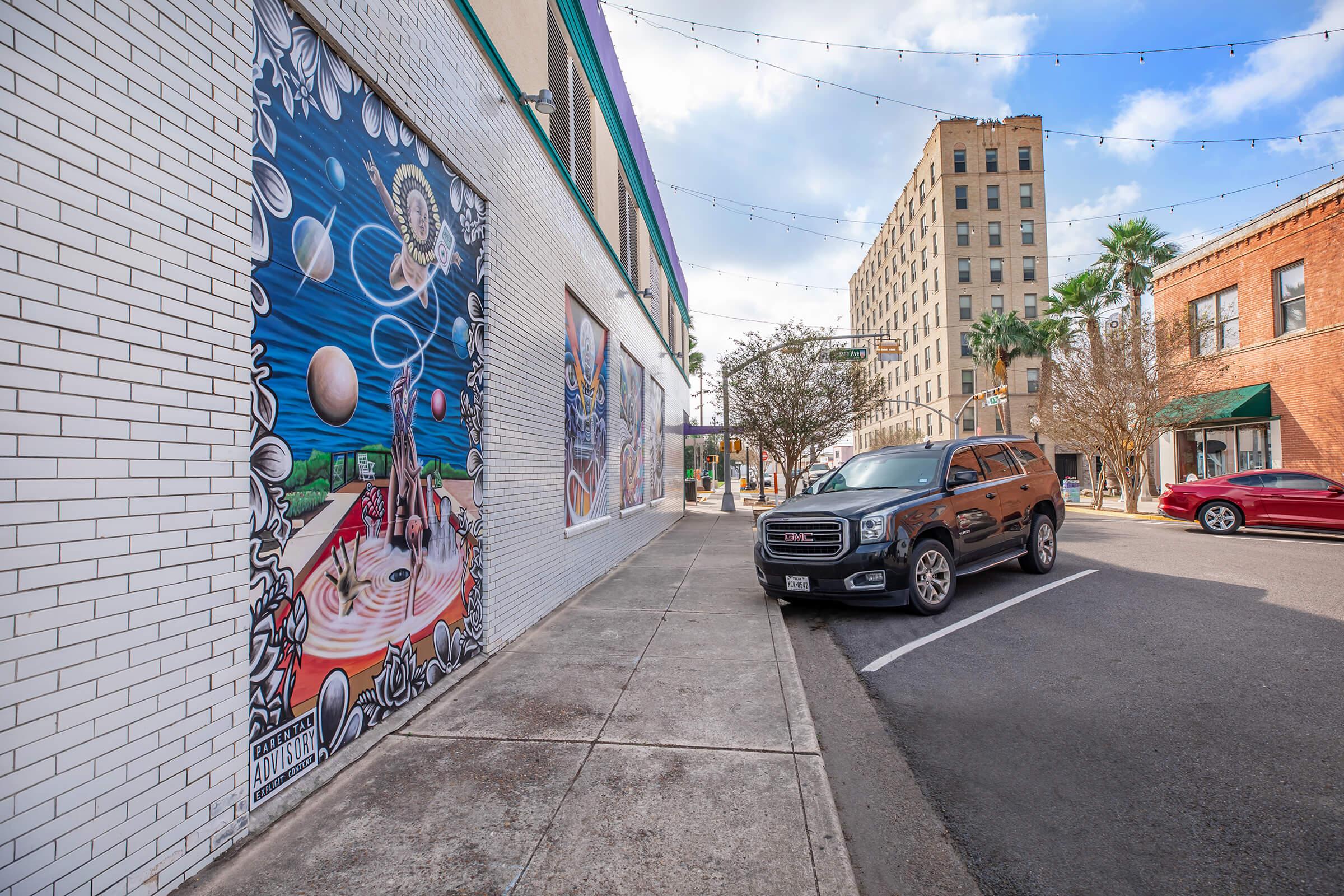 a building with graffiti on the side of a road