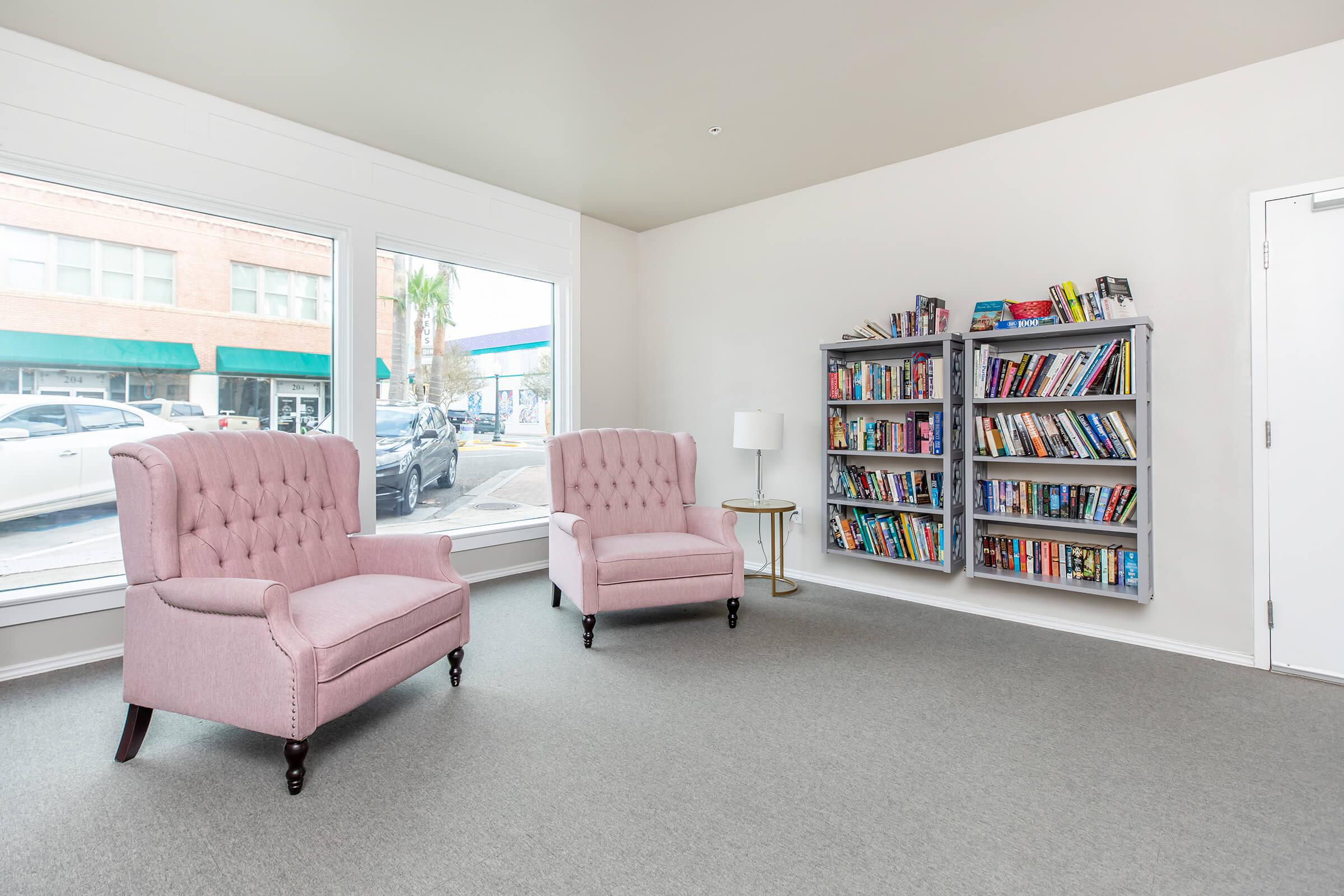 a living room filled with furniture and a large window