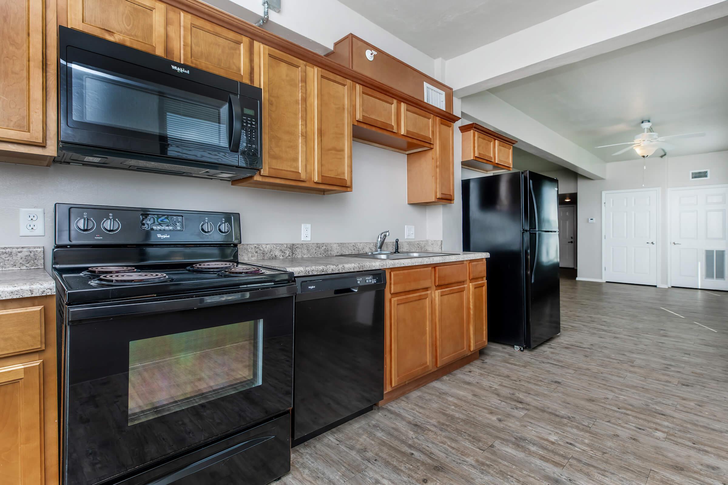 a kitchen with stainless steel appliances and wooden cabinets