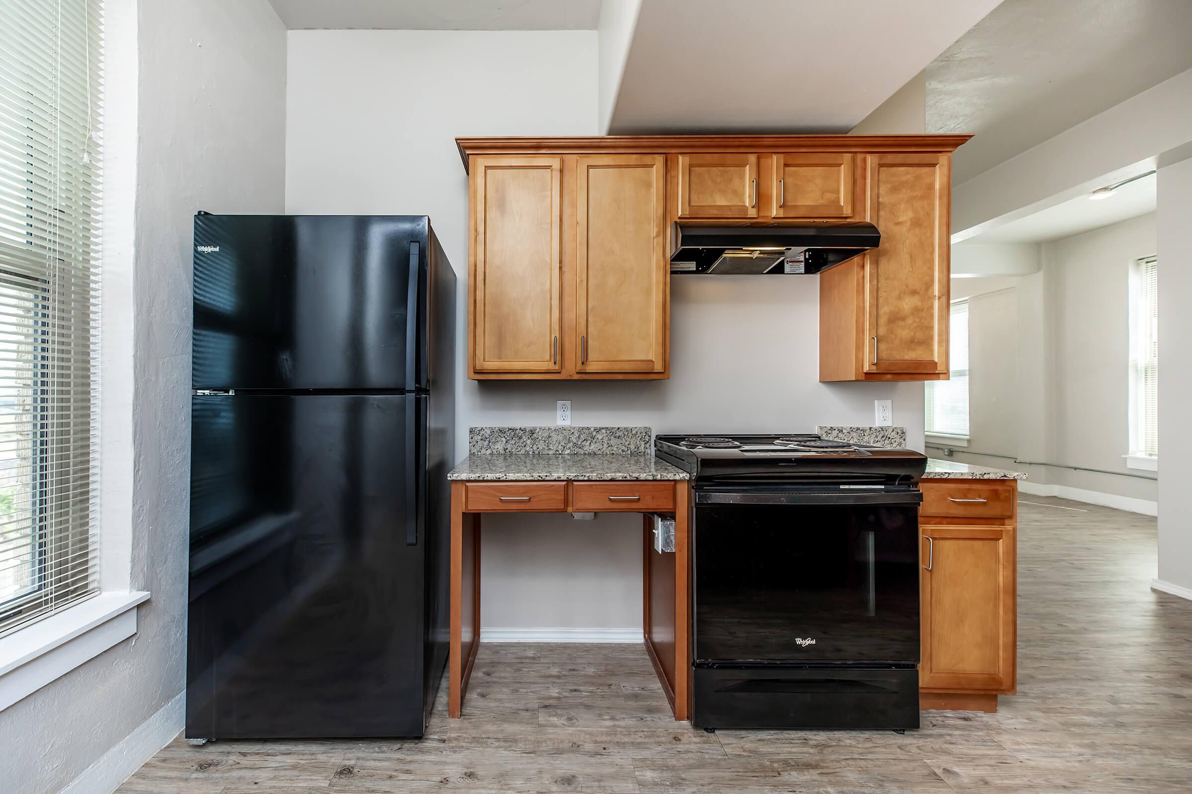 a kitchen with a stove and a refrigerator