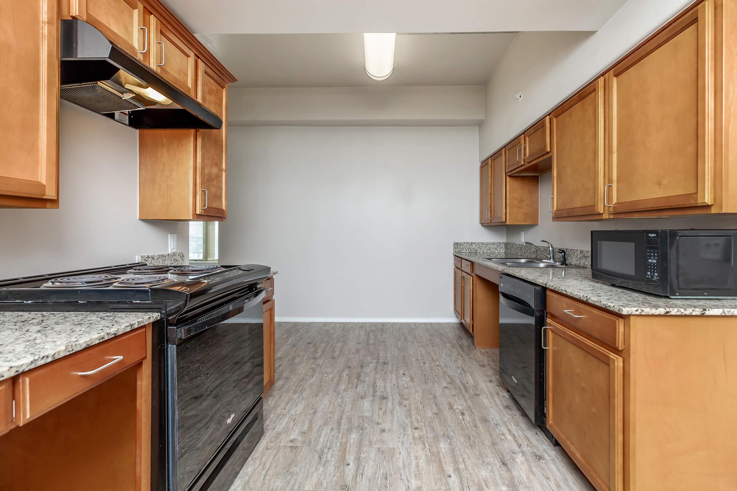 a kitchen with stainless steel appliances and wooden cabinets