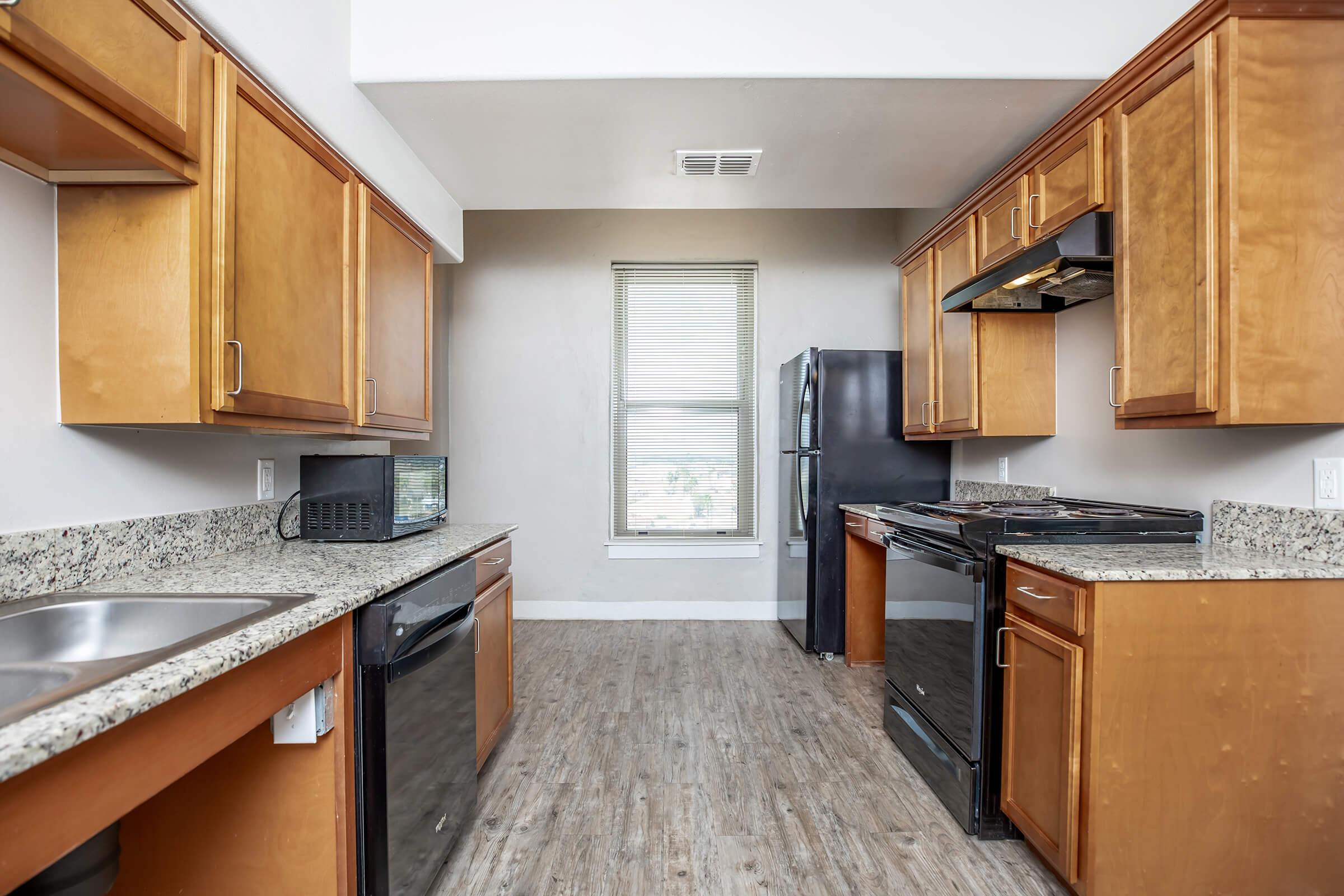 a kitchen with stainless steel appliances and wooden cabinets