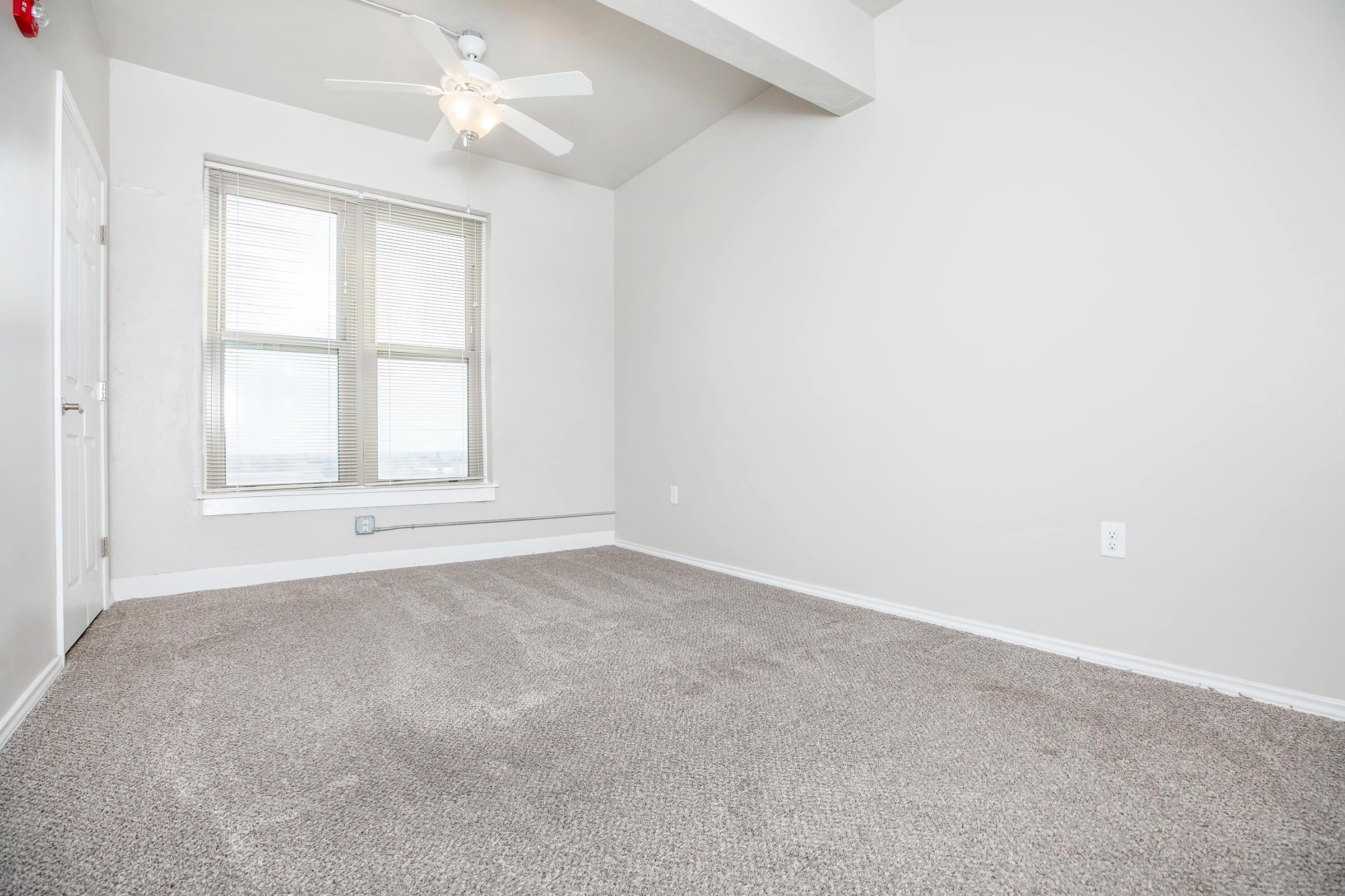 a bedroom with a large window