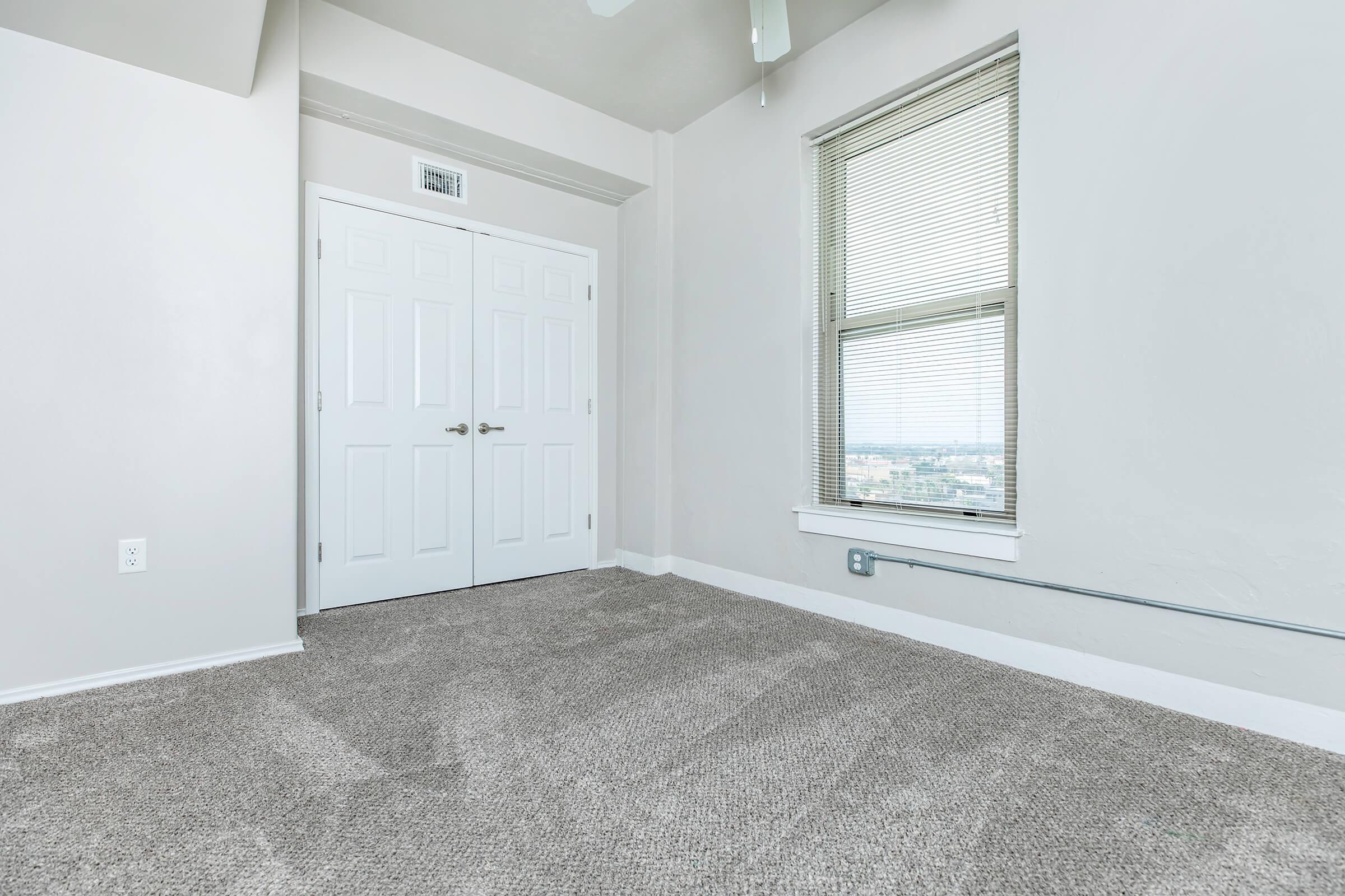 a bedroom with a large window