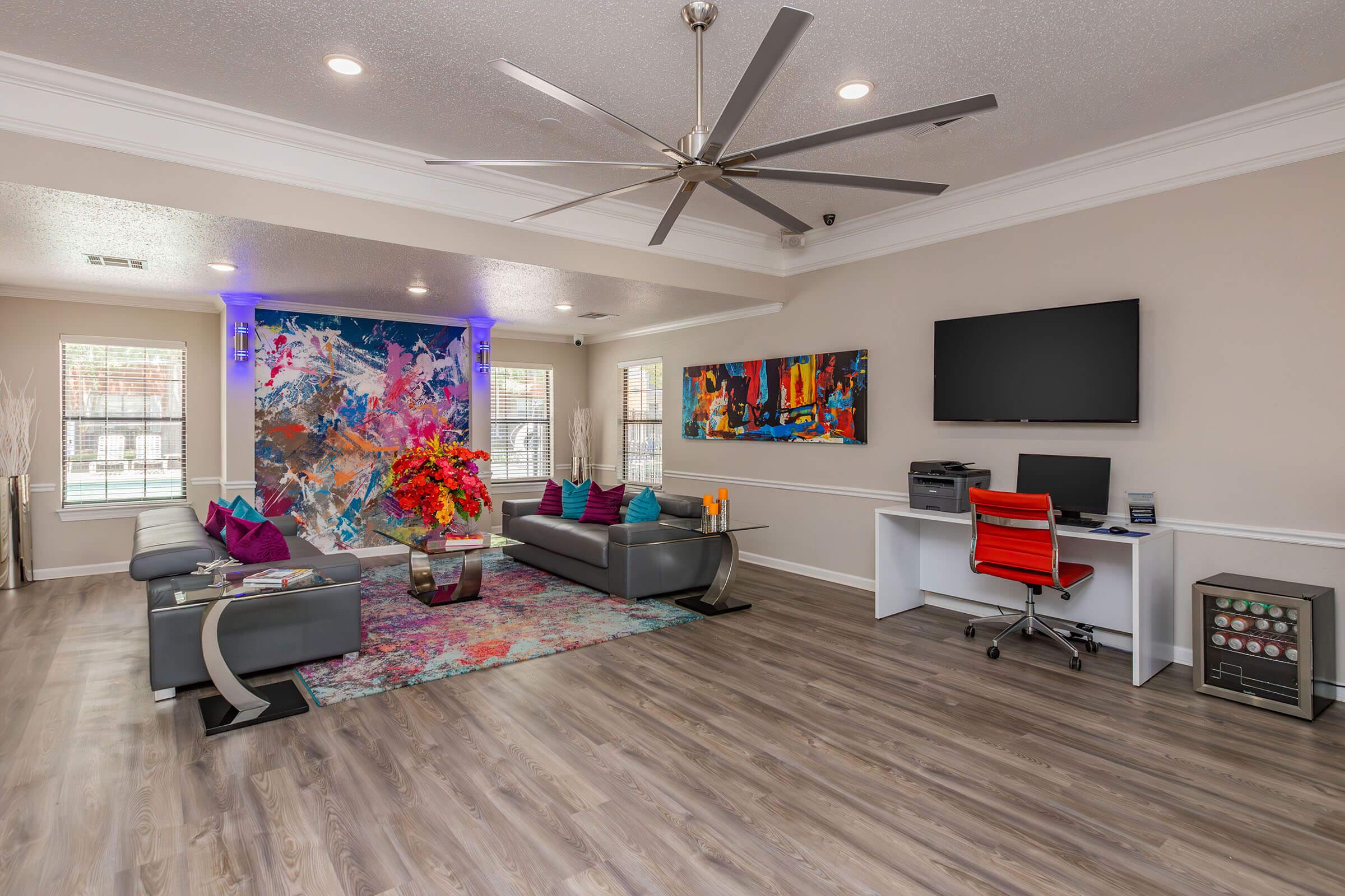 a living room filled with furniture and a flat screen tv