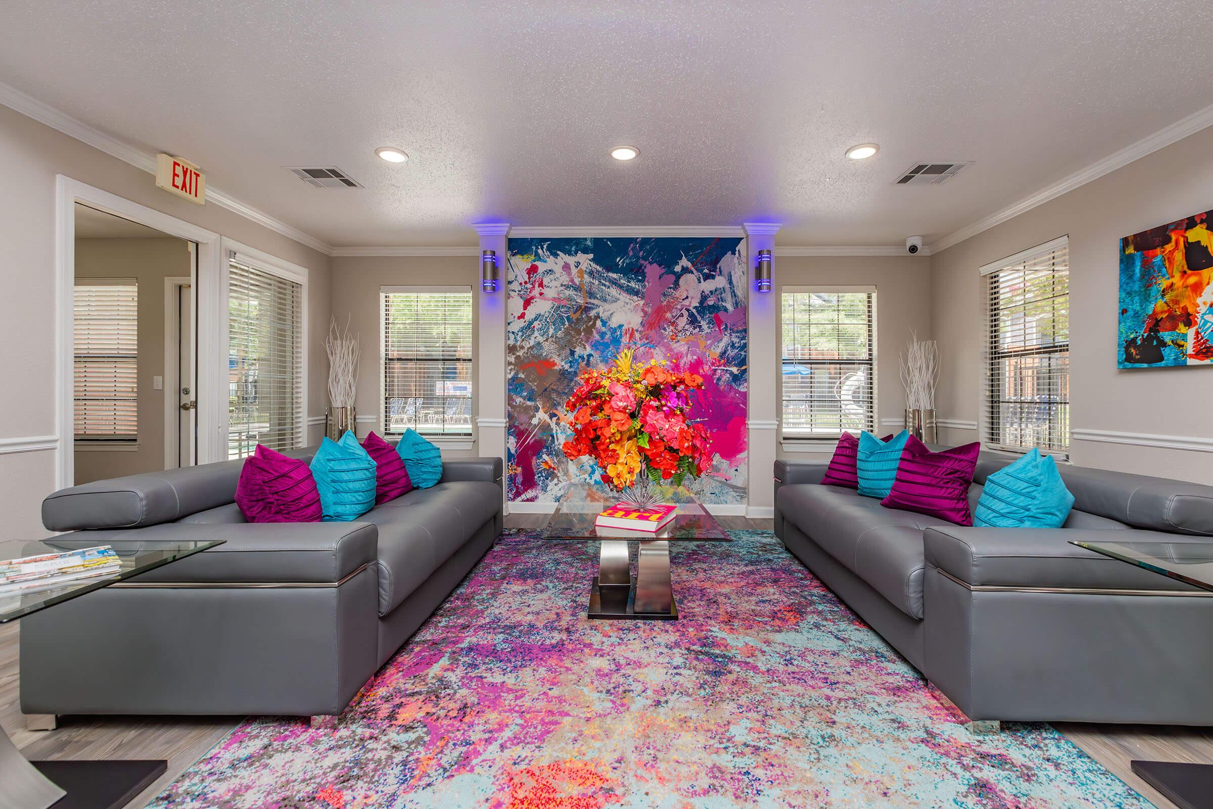 a living room filled with furniture and a flat screen tv