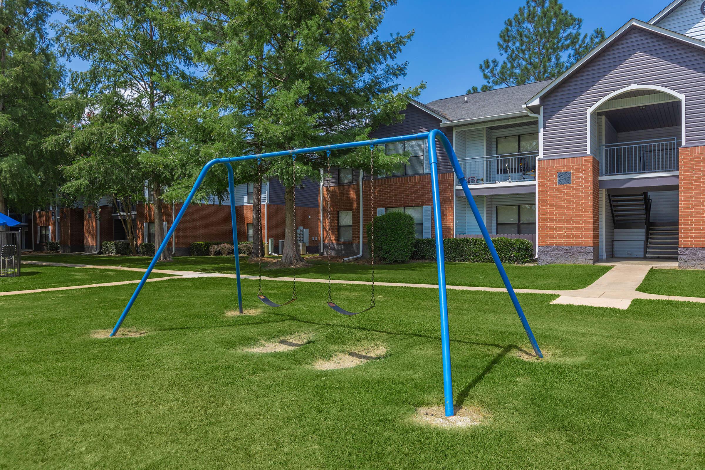 a young boy flying a kite in a yard