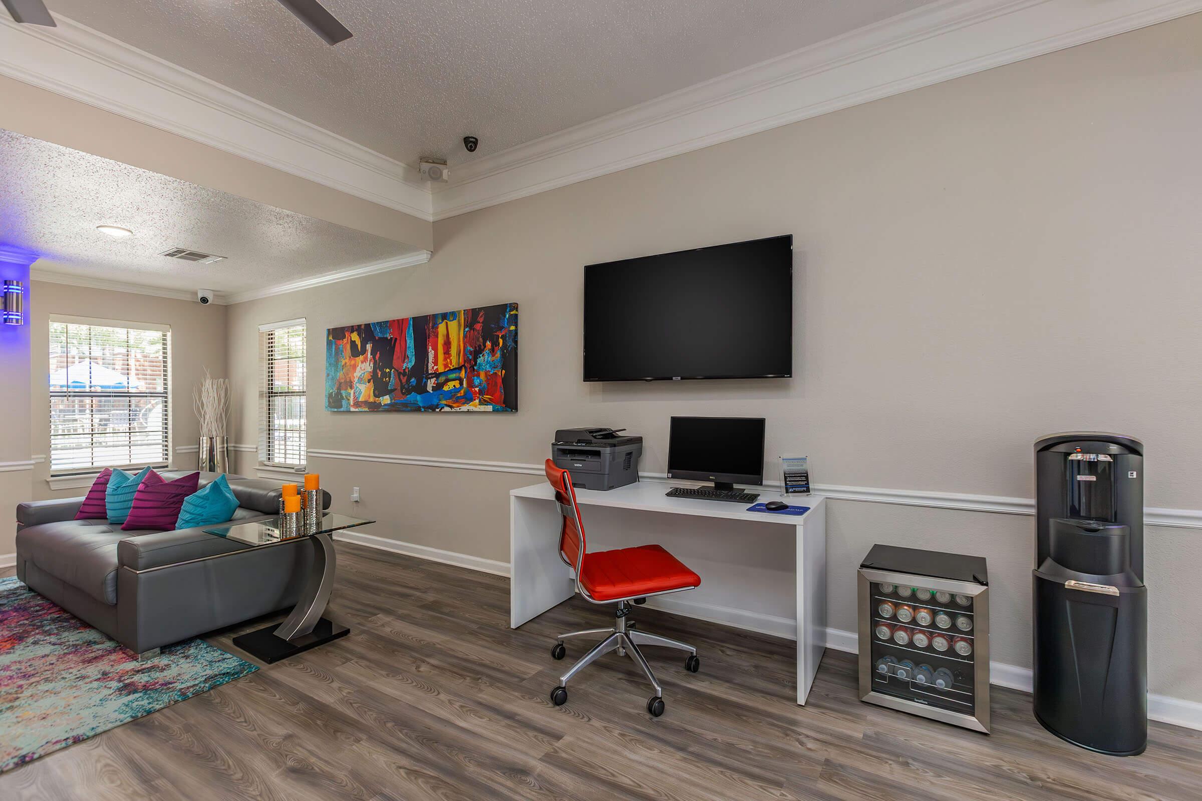 a room filled with furniture and a flat screen tv