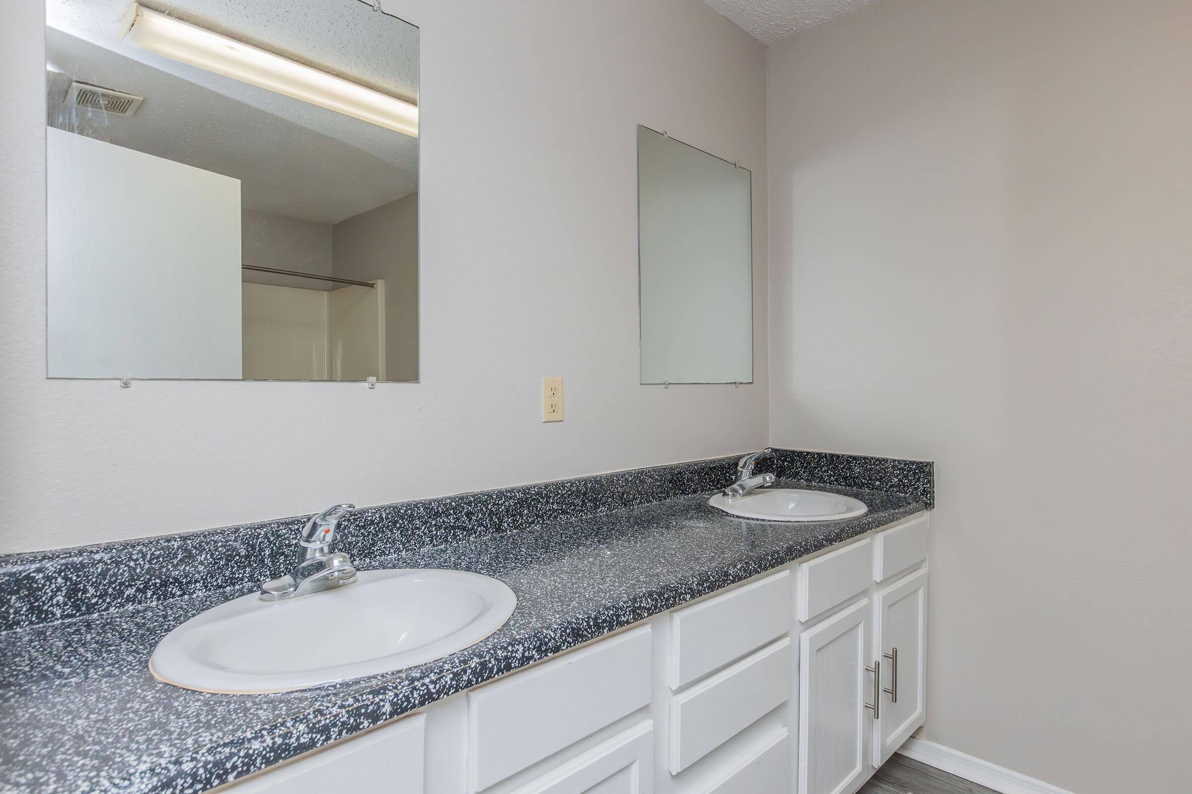 a kitchen with a sink and a mirror