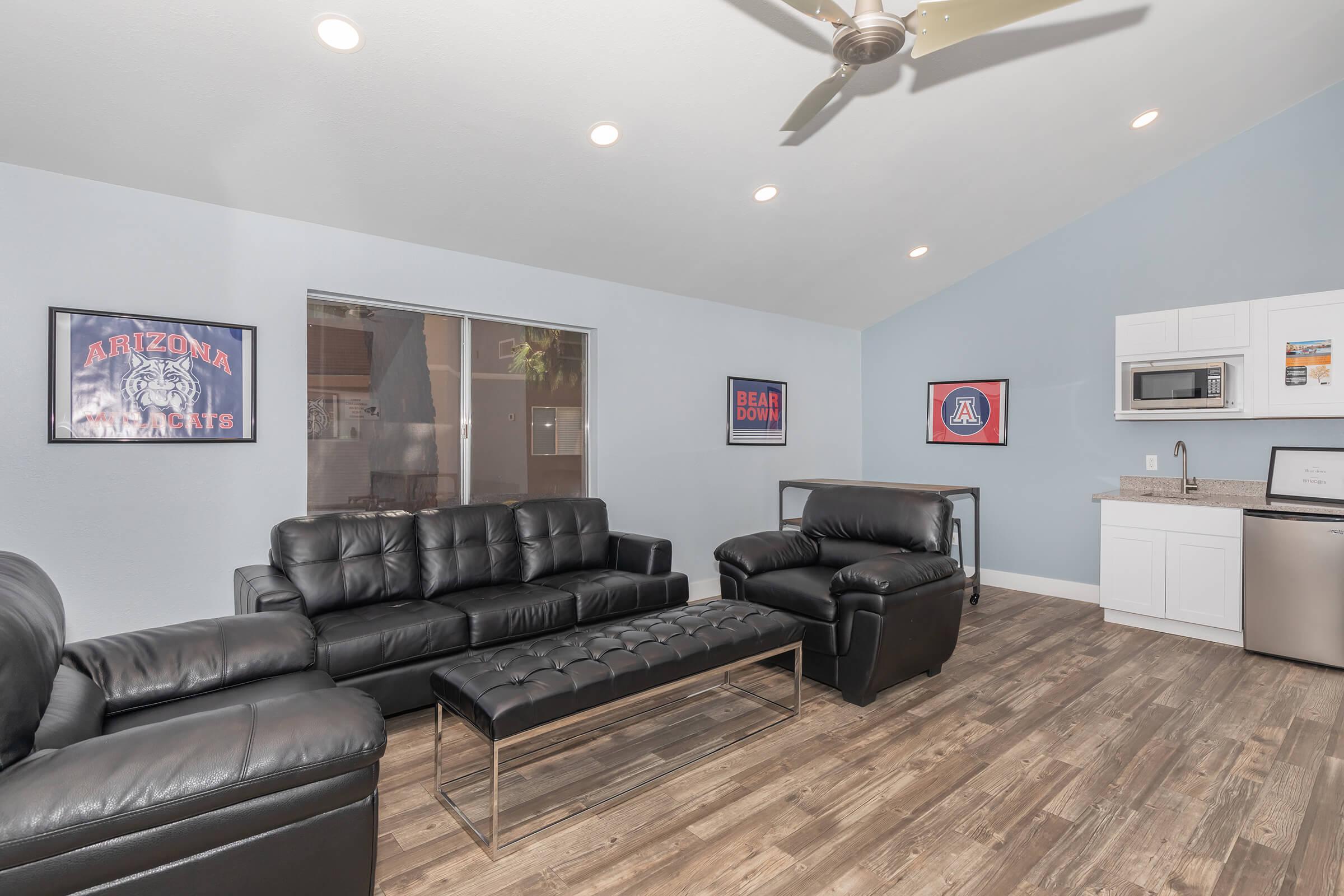 a living room filled with furniture and a flat screen tv