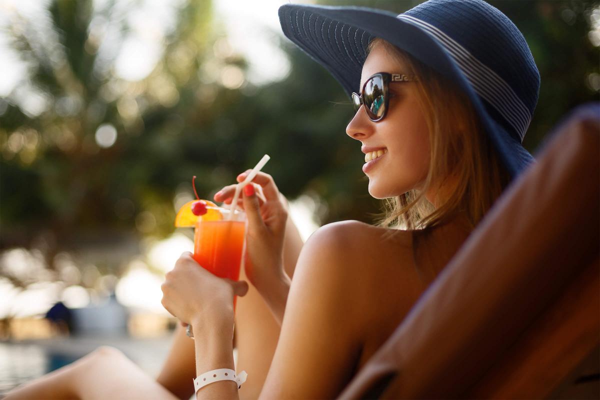 a woman wearing a hat and sunglasses