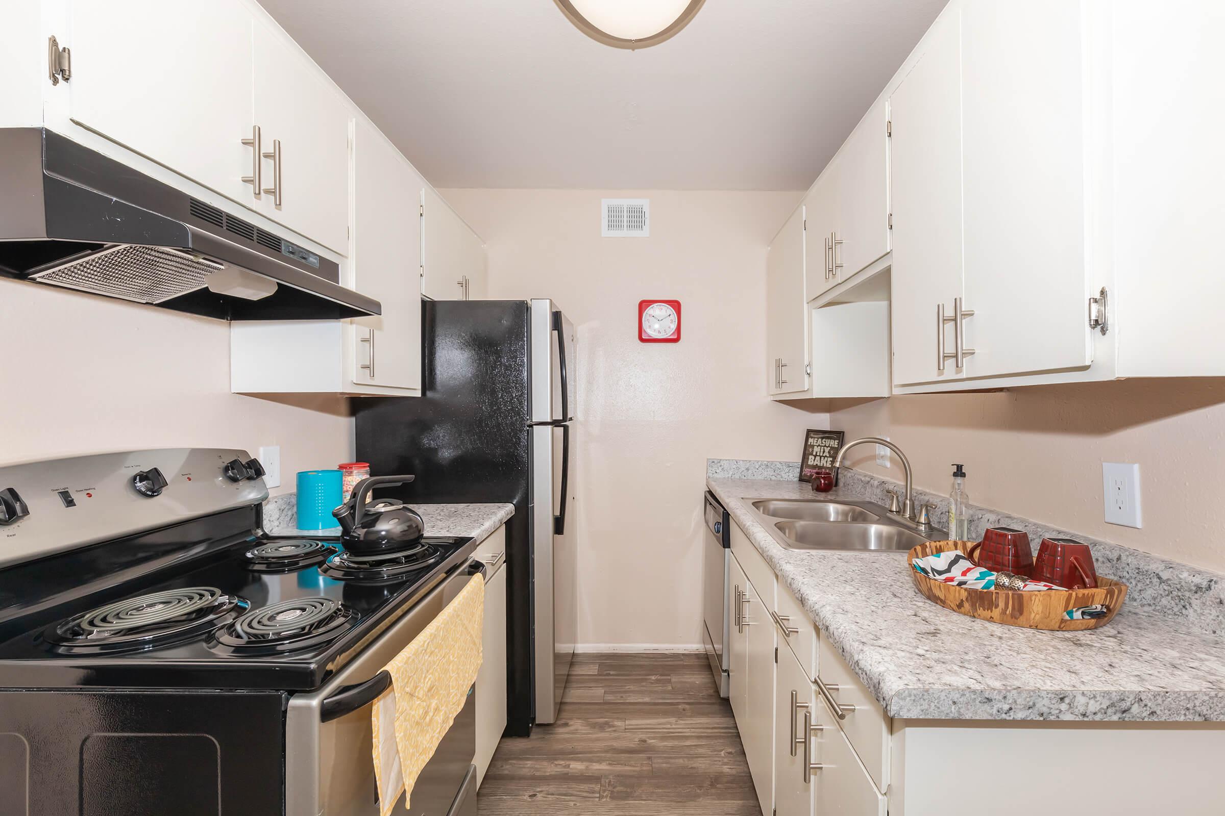 a kitchen with a stove sink and refrigerator