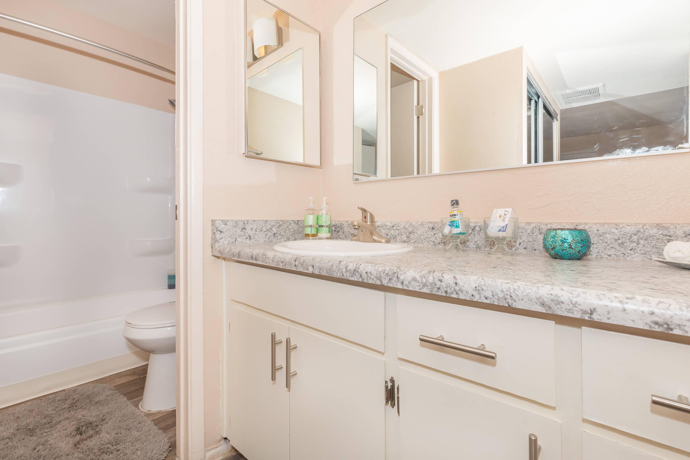 a kitchen with a sink and a mirror