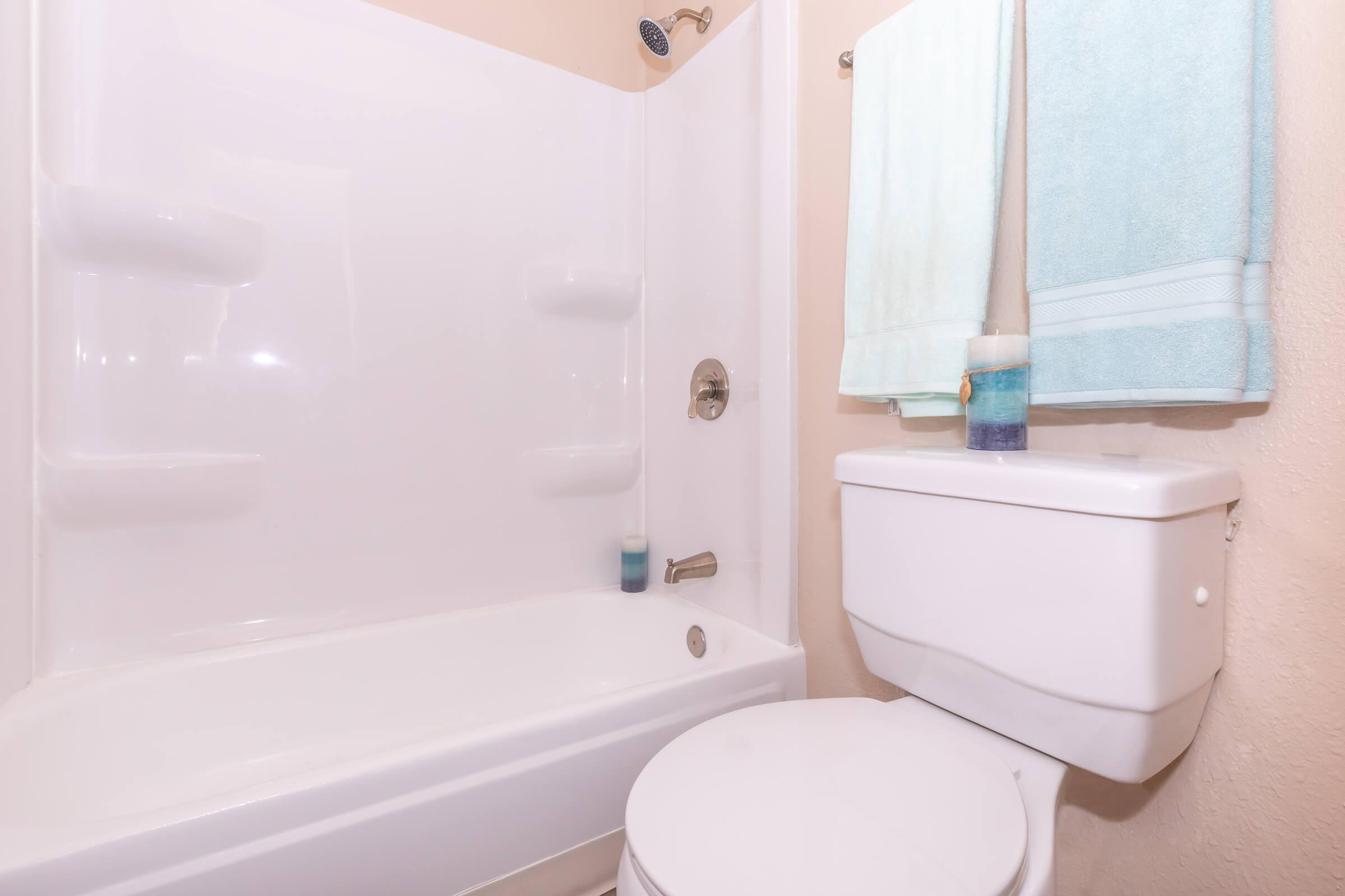 a white tub sitting next to a shower