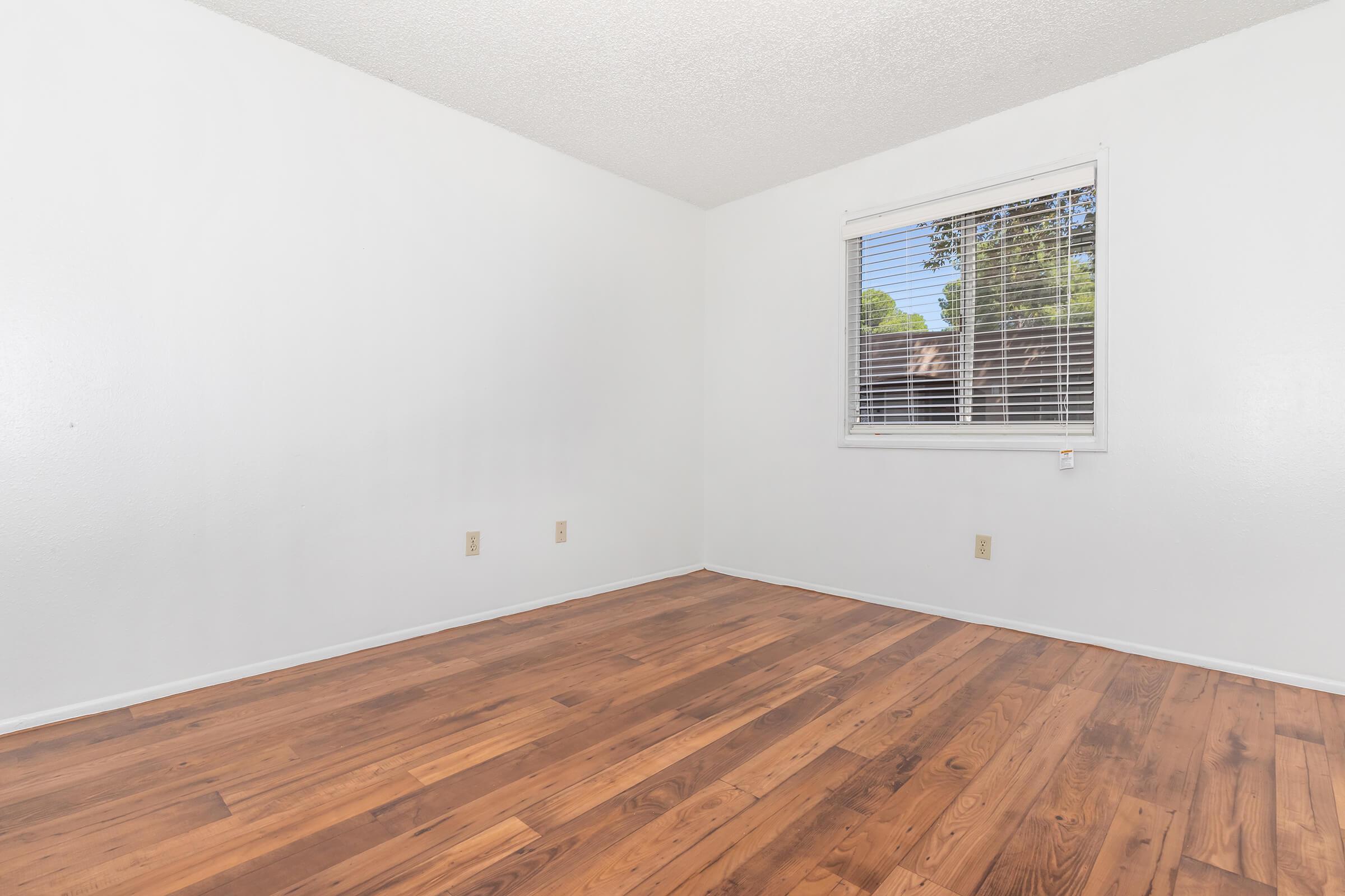 a large empty room with a wooden floor