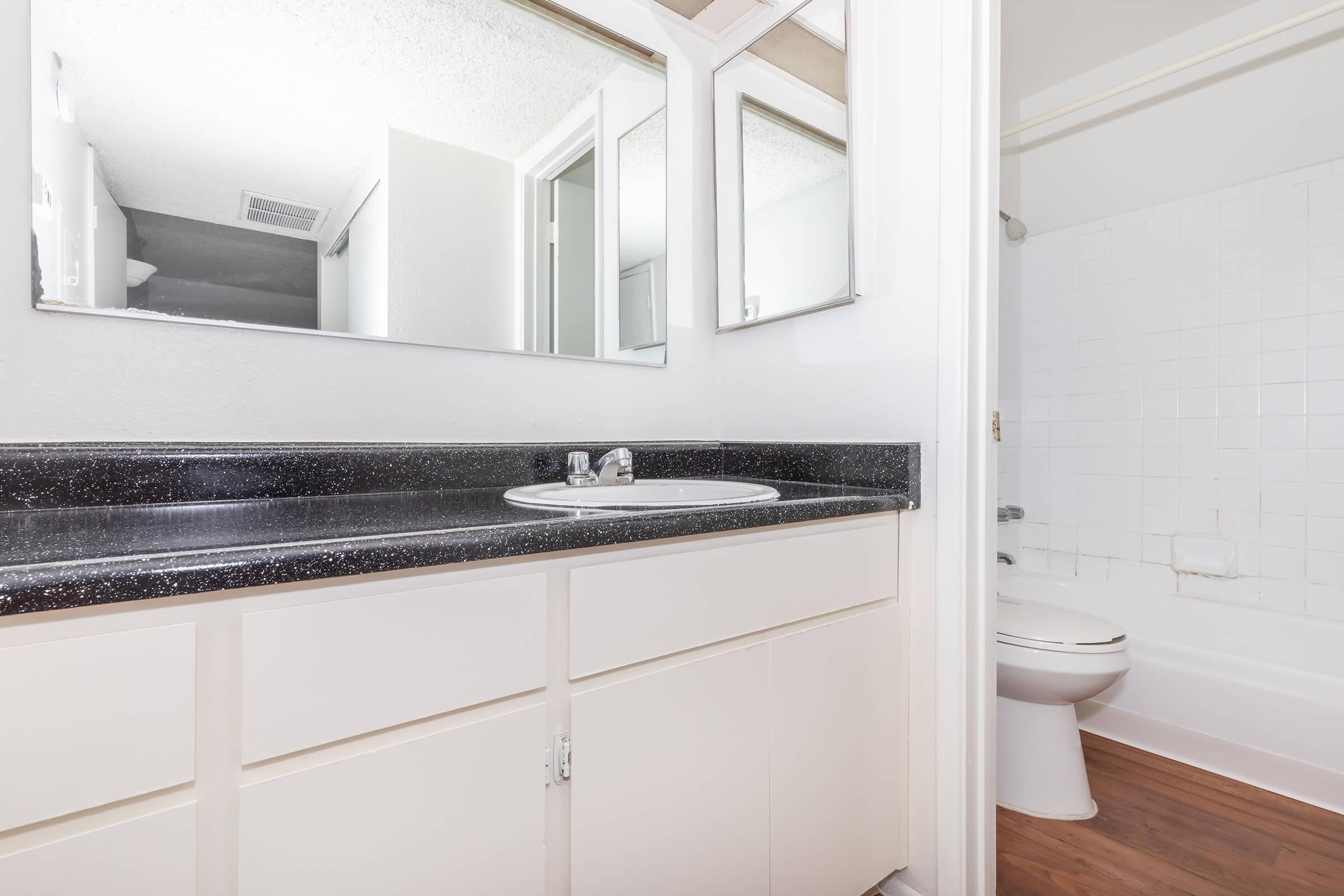 a white sink sitting under a window