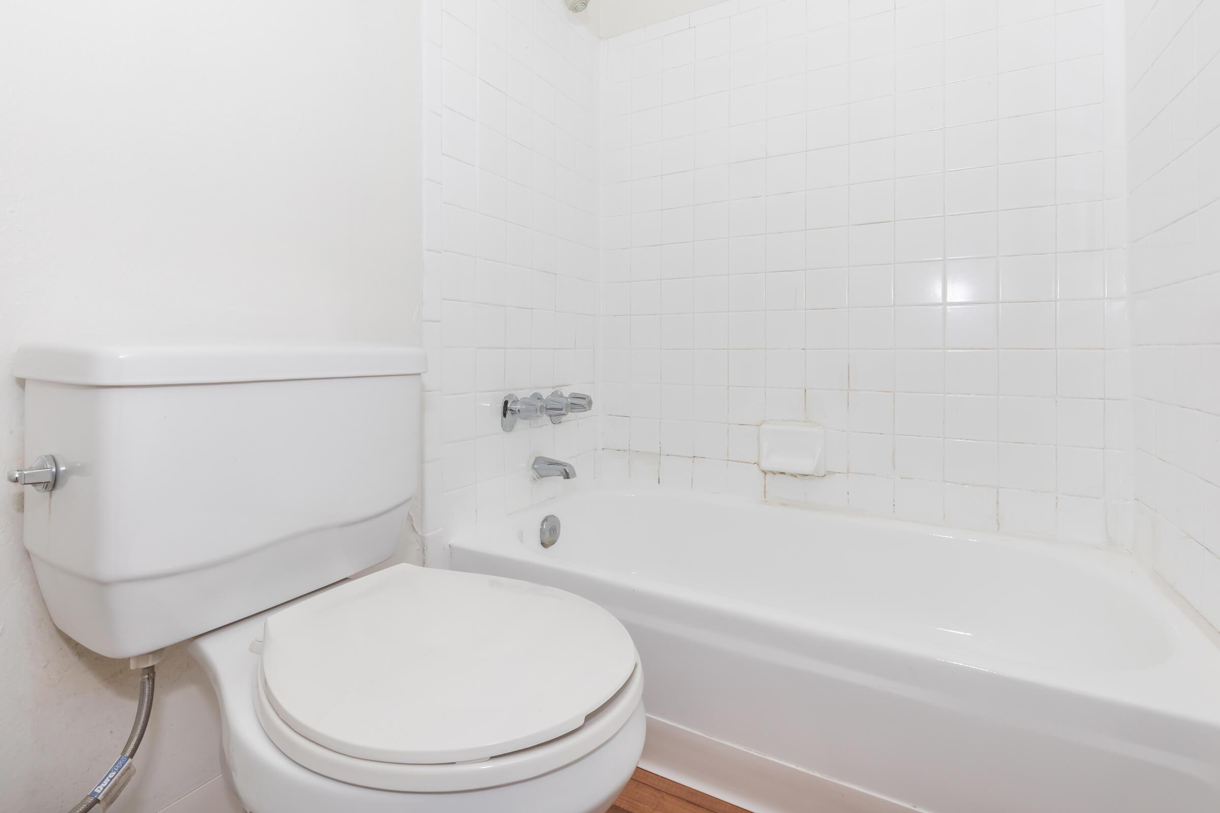 a white tub sitting next to a sink