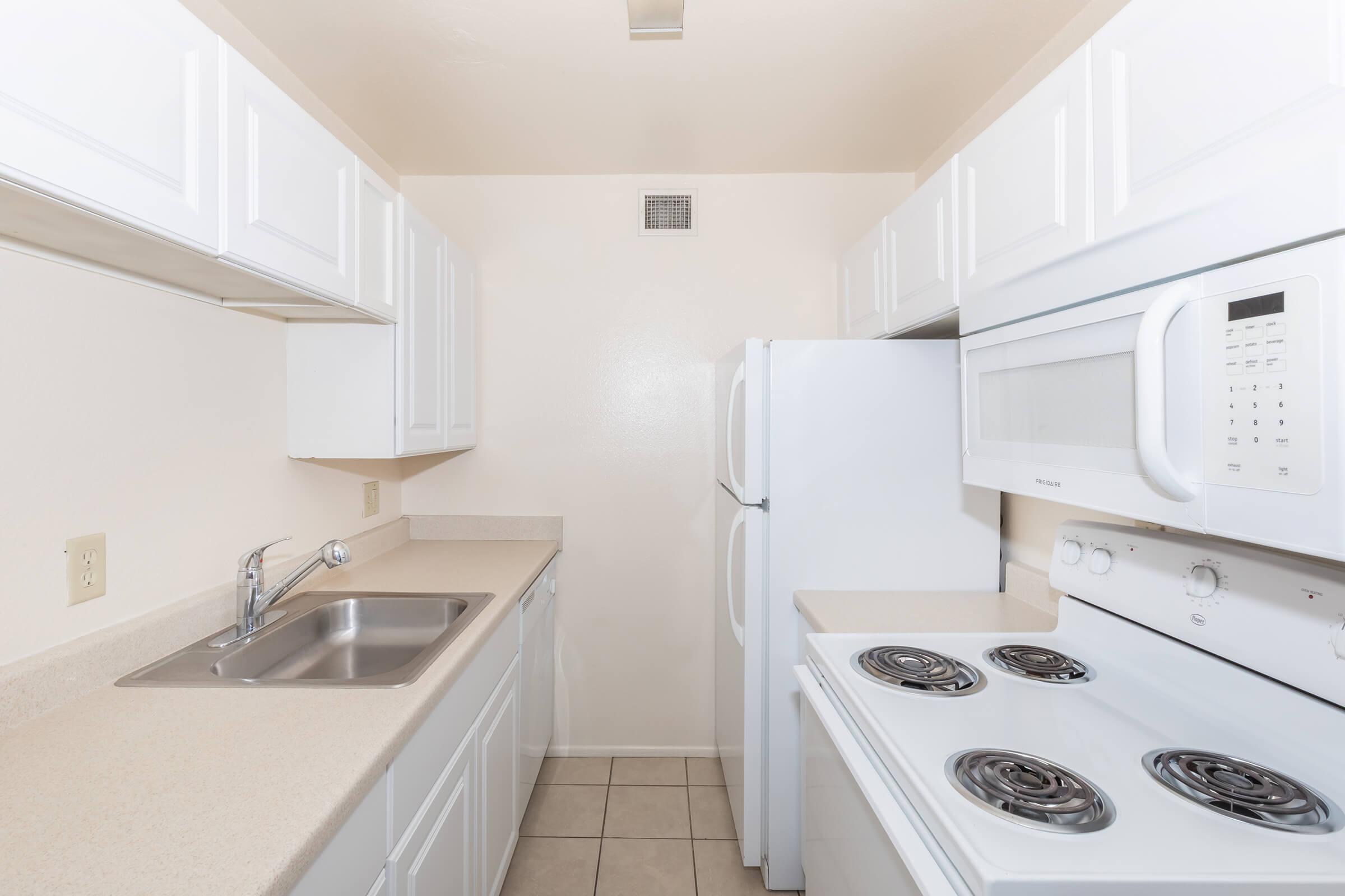 a white stove top oven sitting inside of a kitchen