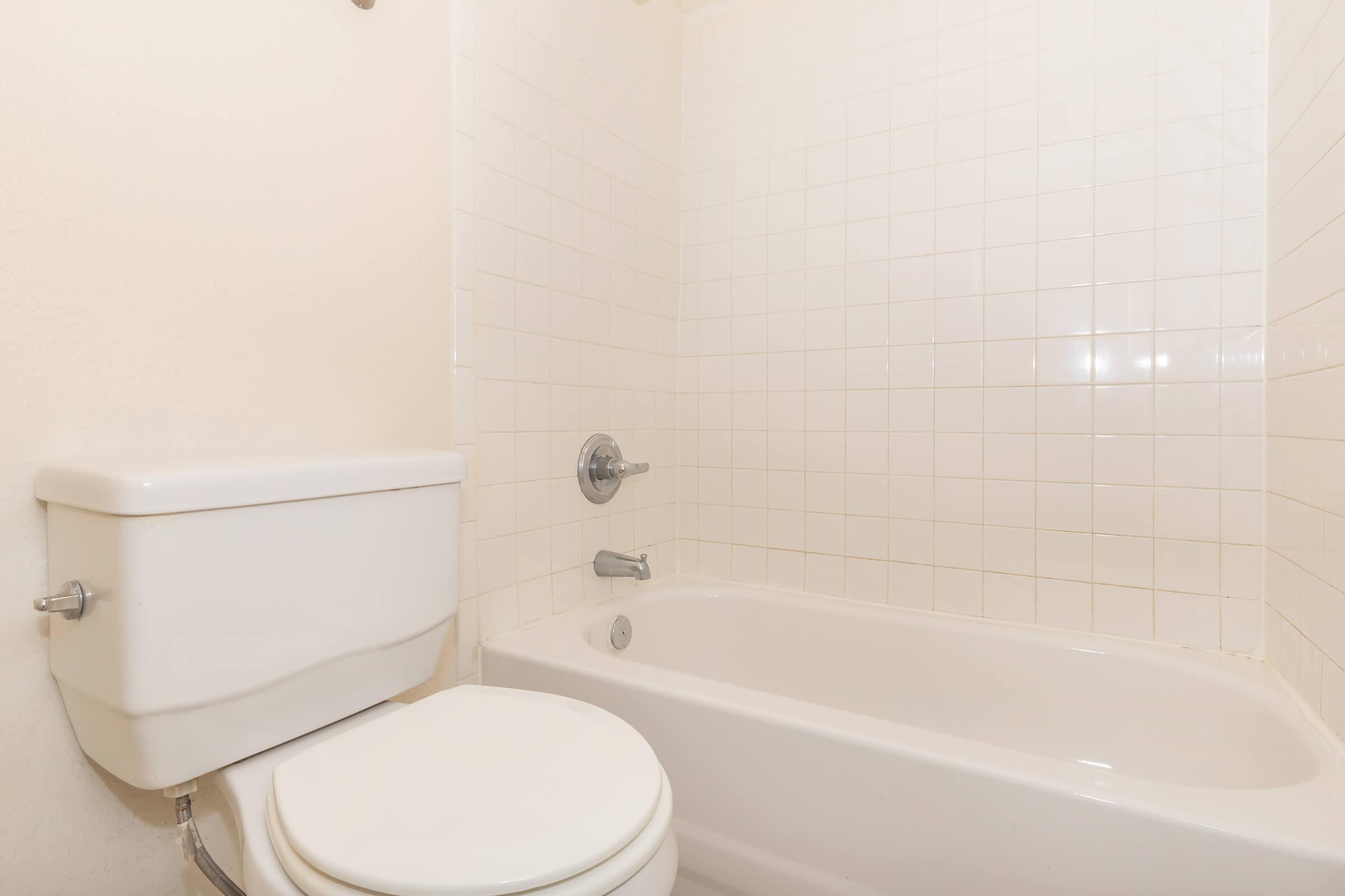 a white tub sitting next to a sink