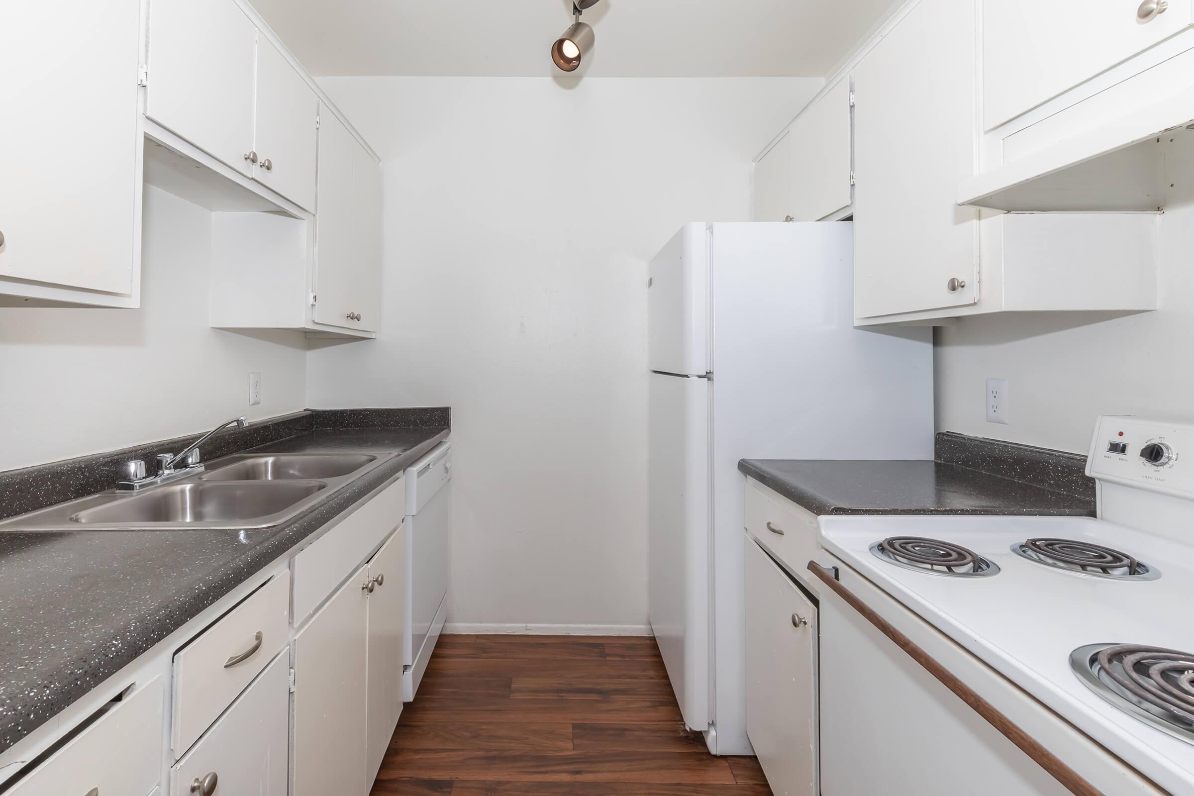 a kitchen with a stove sink and refrigerator