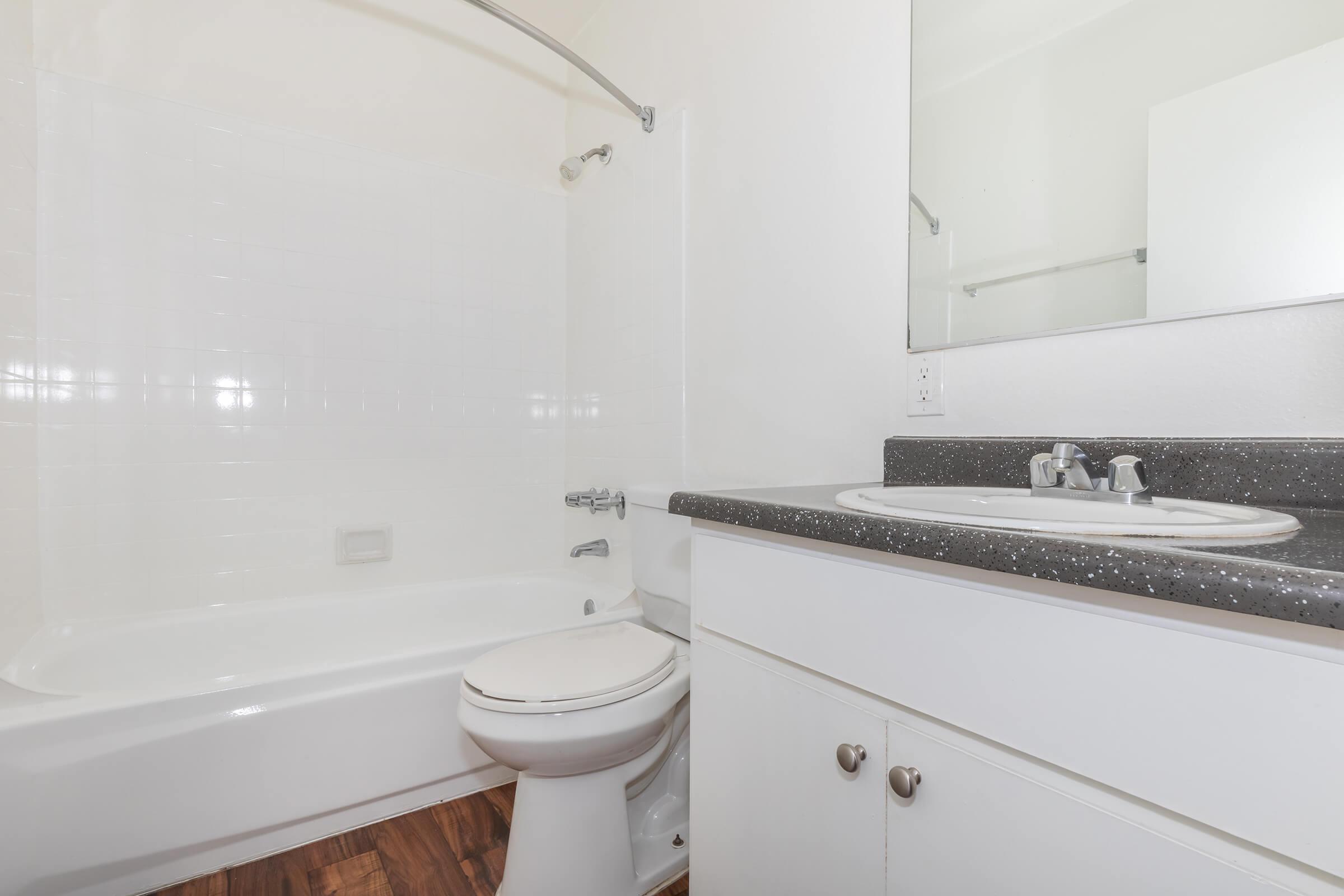 a white tub sitting next to a shower