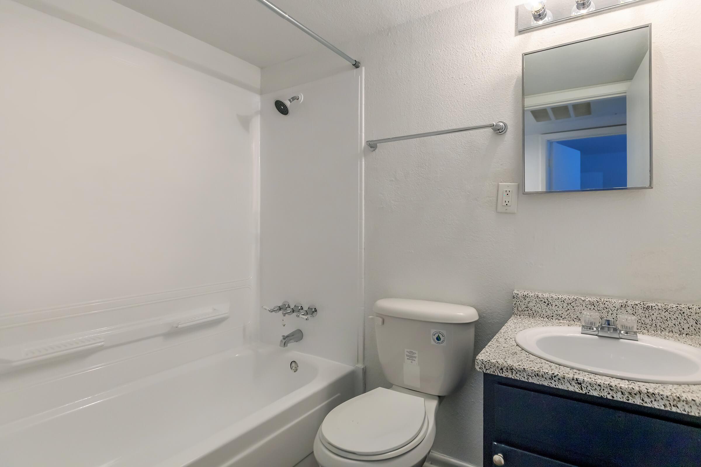 a white tub sitting next to a sink