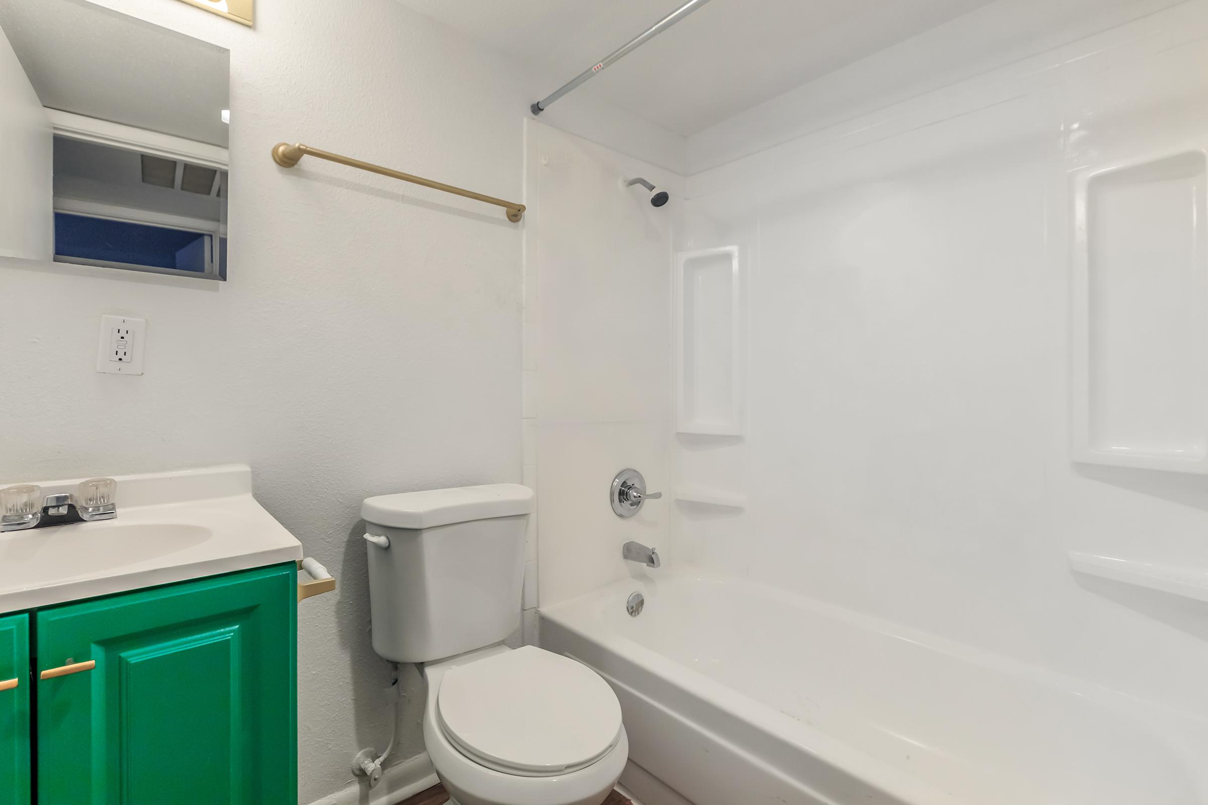 a white sink sitting under a mirror