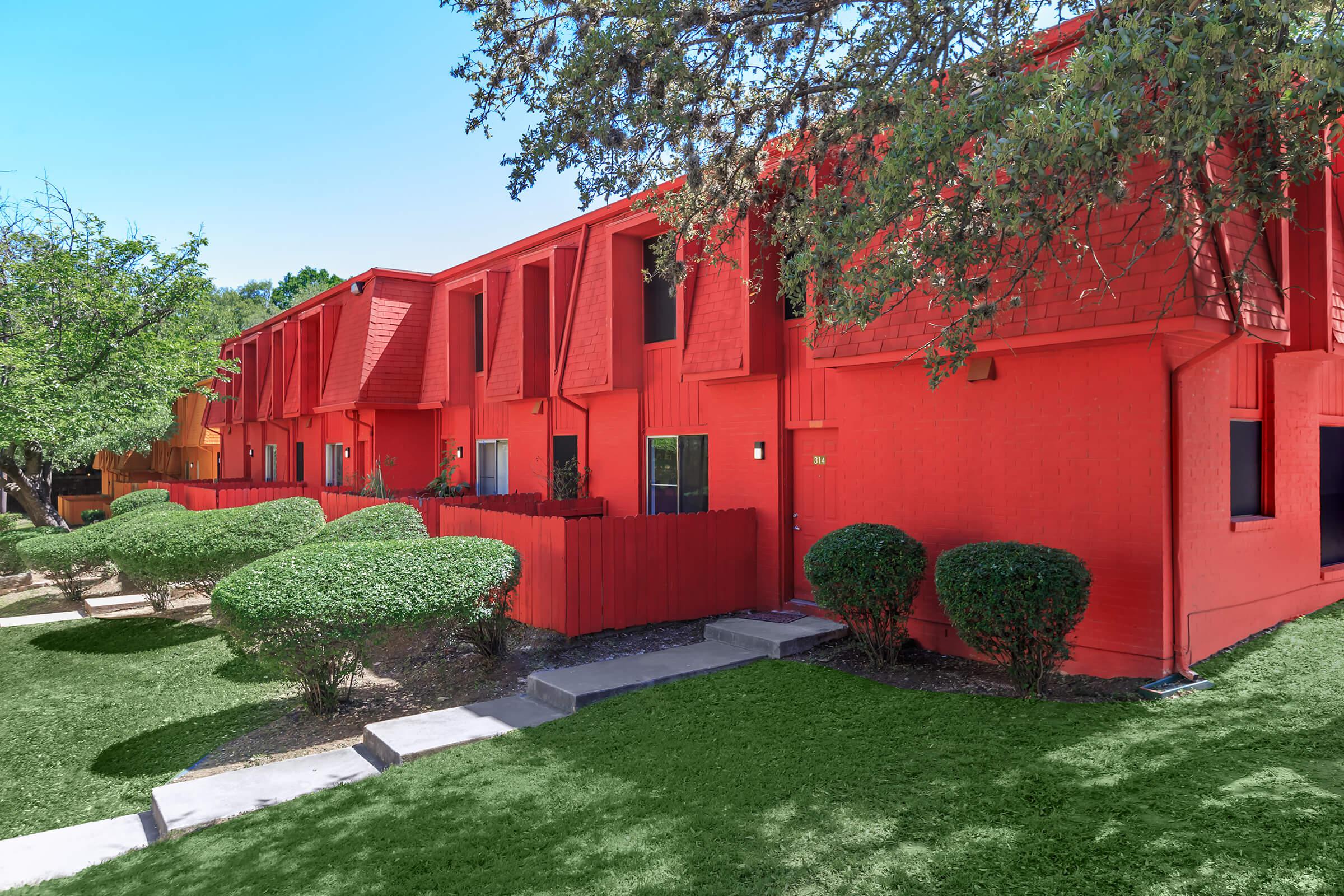 a red and green lawn in front of a house