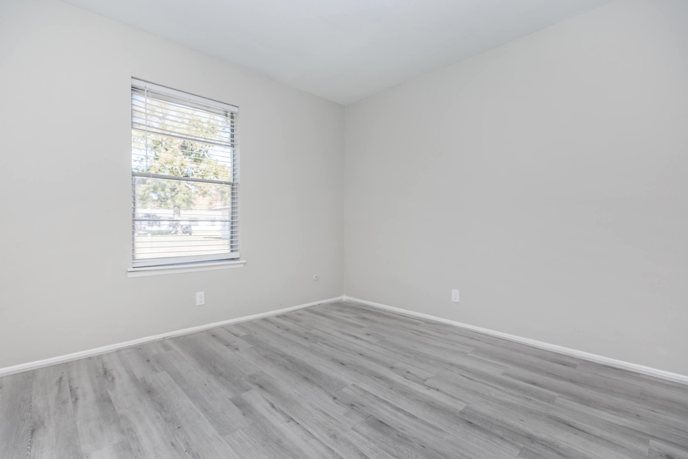 a bedroom with a wooden floor