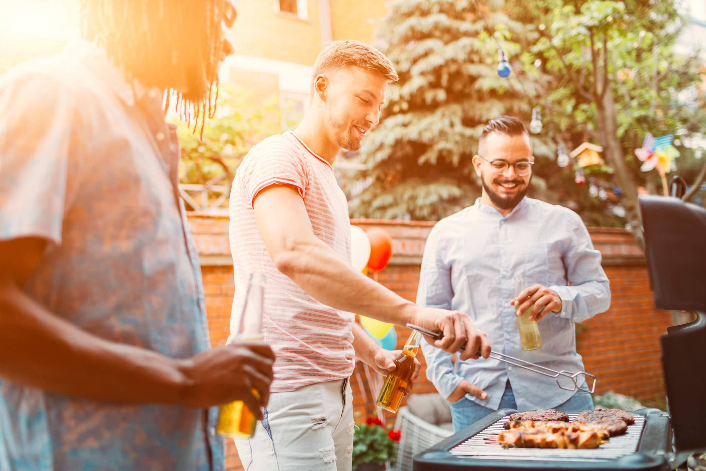 a group of people standing around a table with food