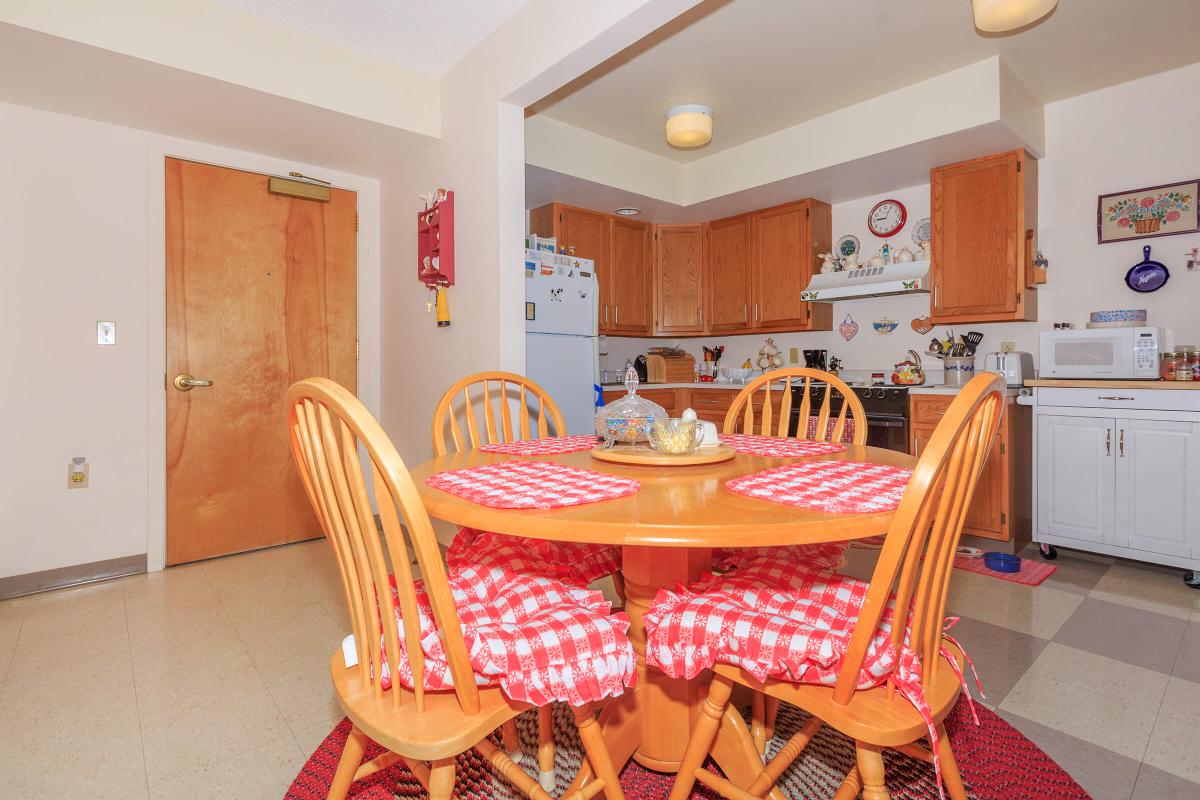 a kitchen with a red chair in a room