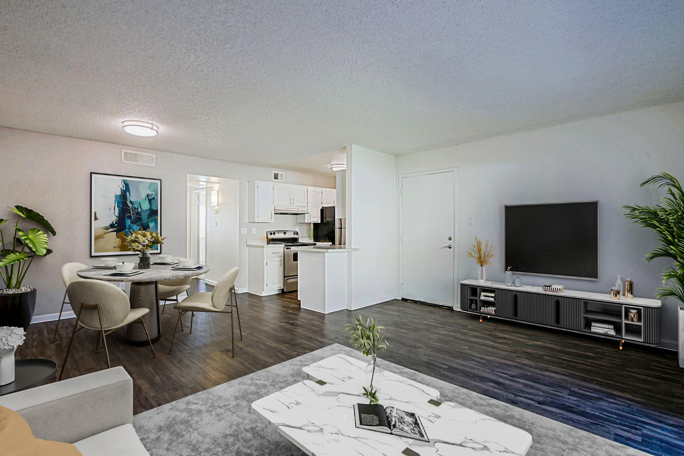 A modern living room featuring a cozy seating area with a marble coffee table, a dining space with a round table and four chairs, and a contemporary kitchen in the background. There's a large TV on a stylish cabinet and decorative plants add a touch of greenery. The overall ambiance is bright and inviting.