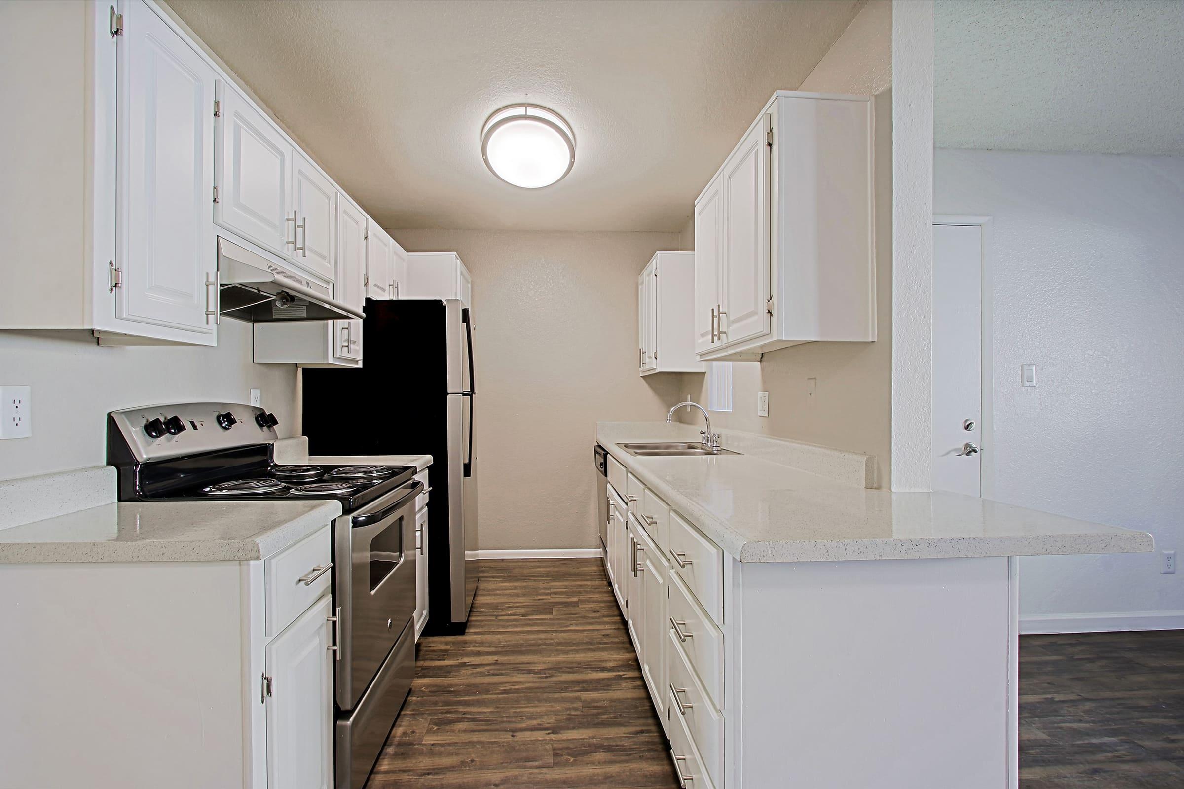 a kitchen with a stove and a refrigerator