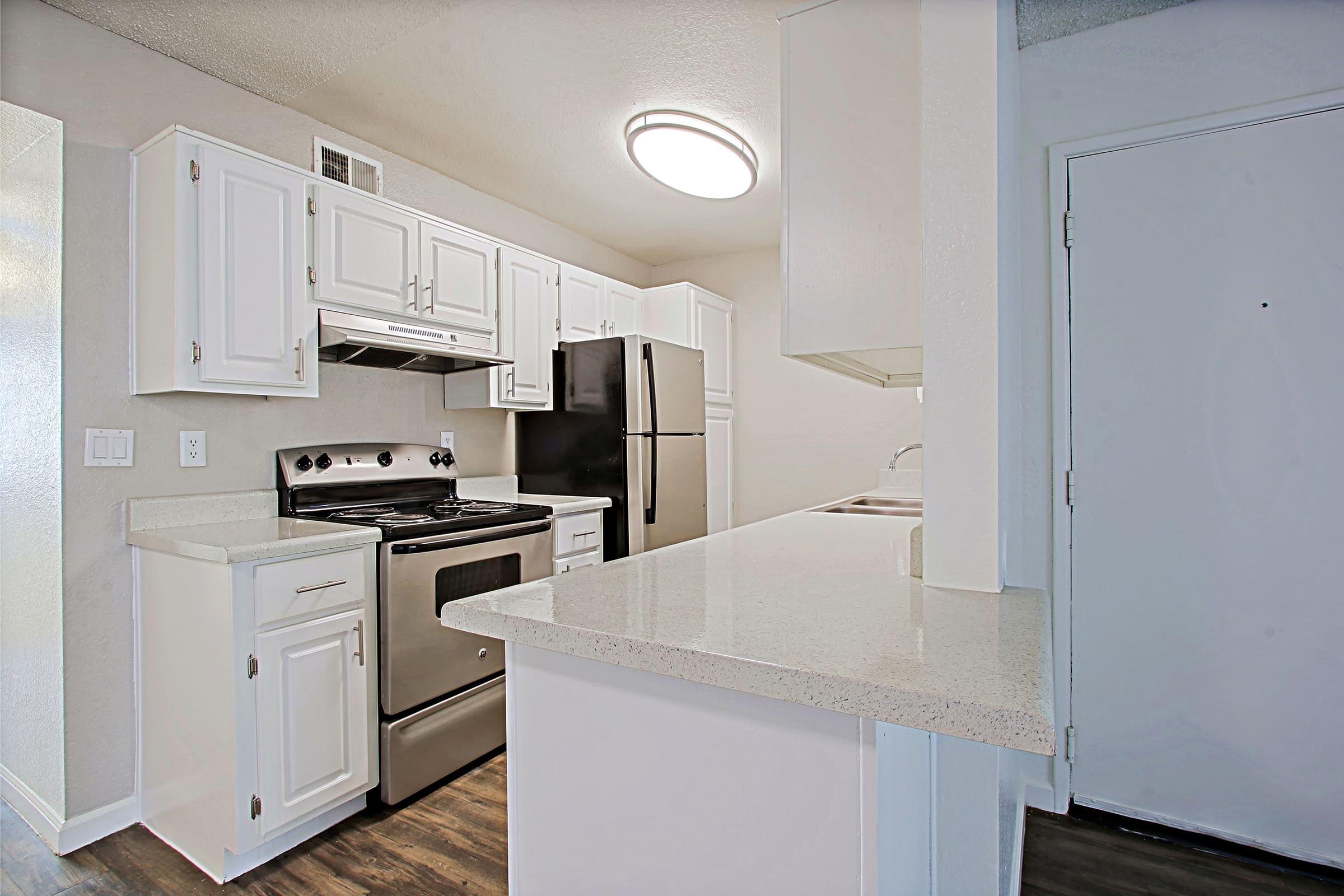 a kitchen with a stove and a refrigerator