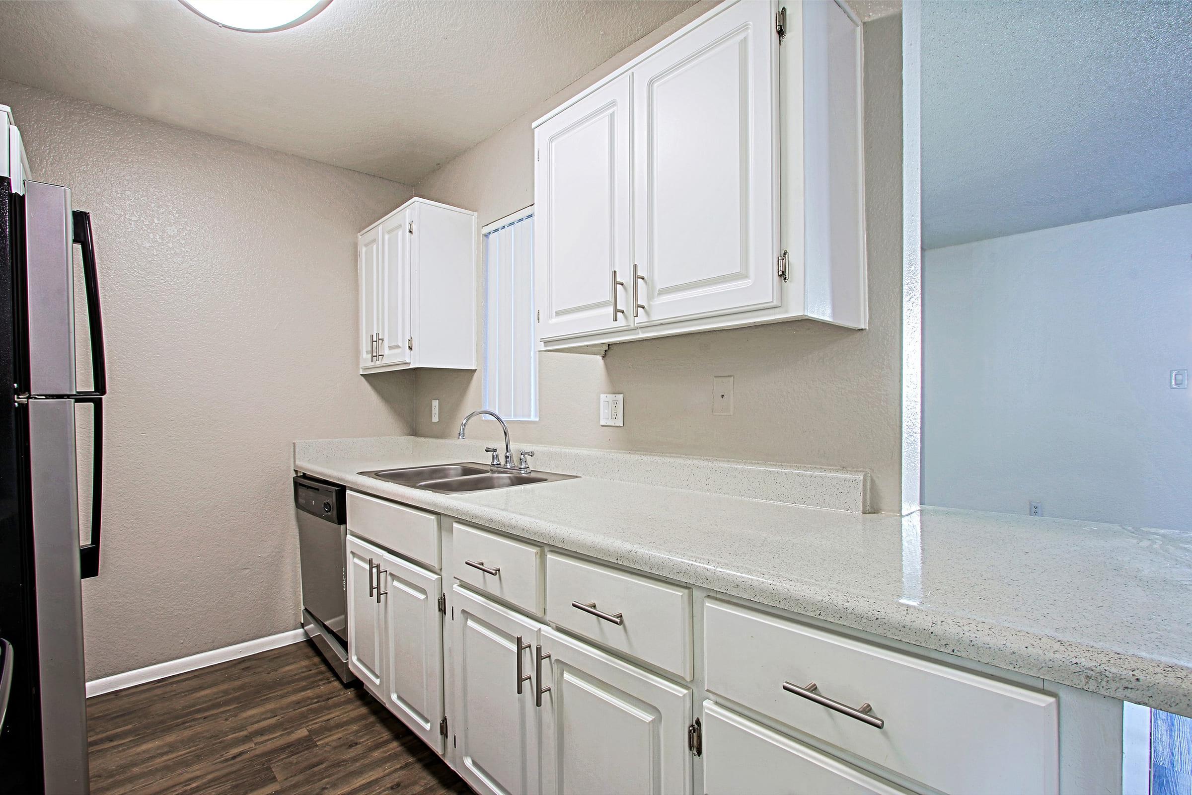 a kitchen with a sink and a mirror