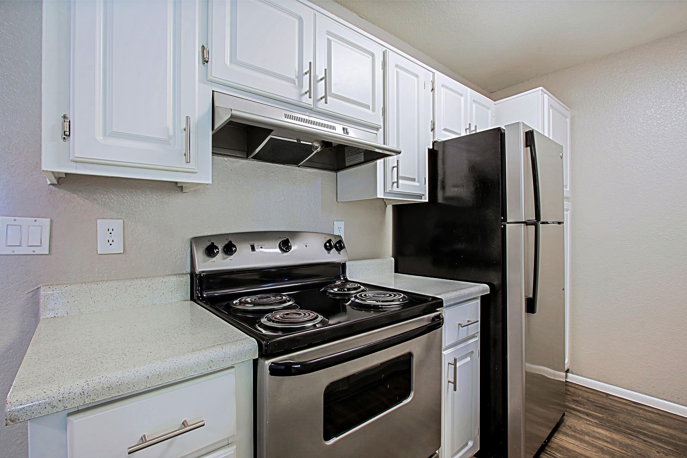 a stove top oven sitting inside of a kitchen