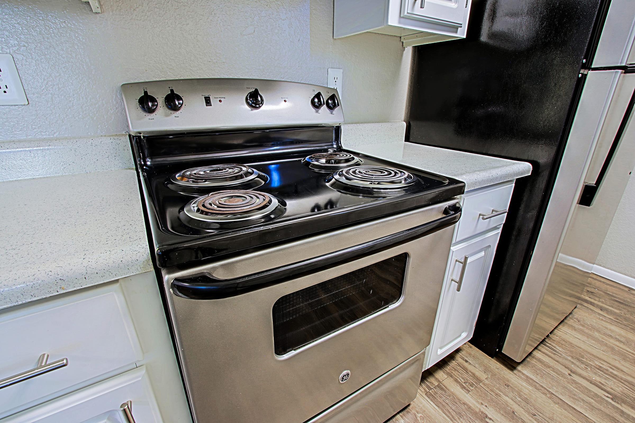 a stove top oven sitting inside of a kitchen