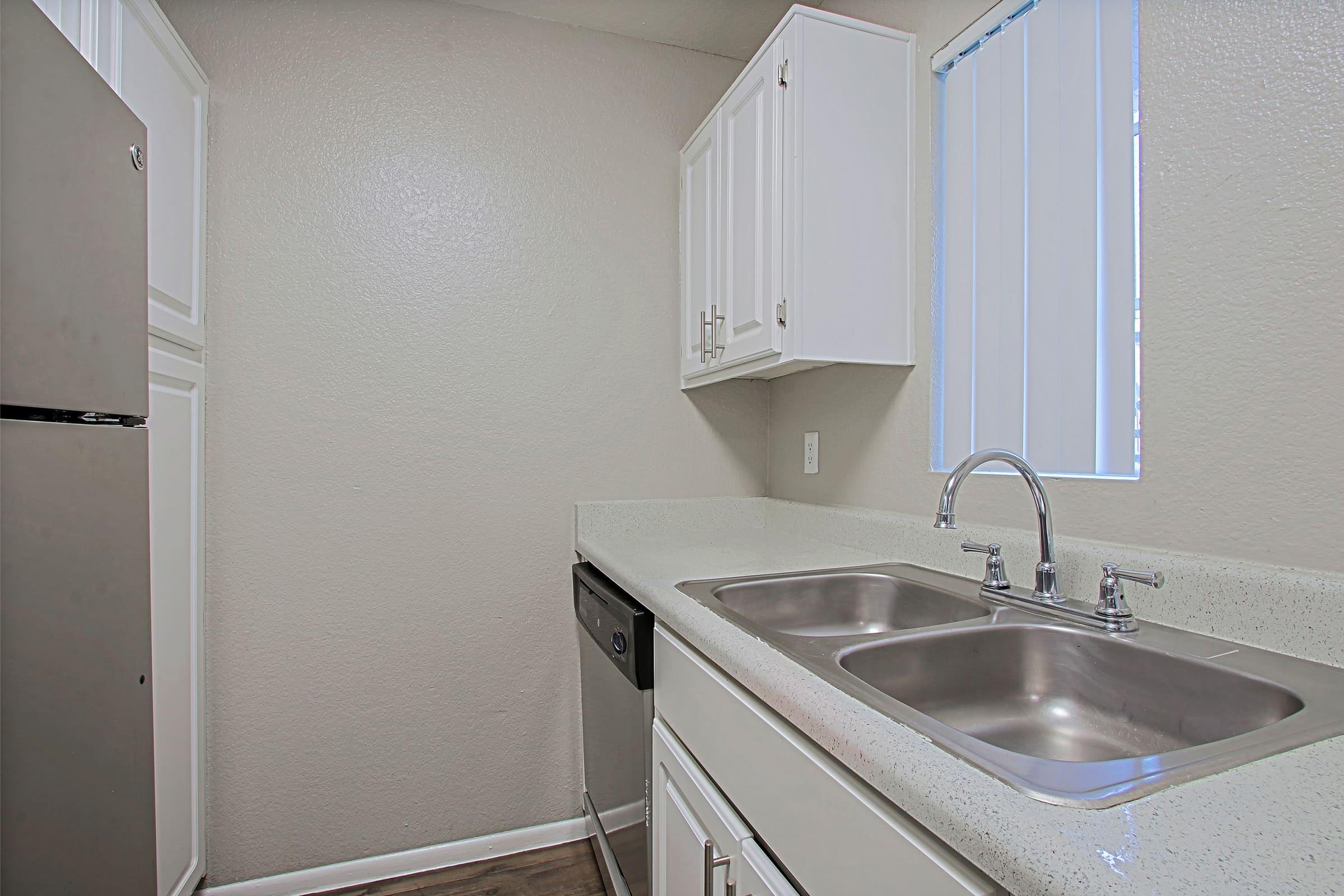 a kitchen with a sink and a mirror