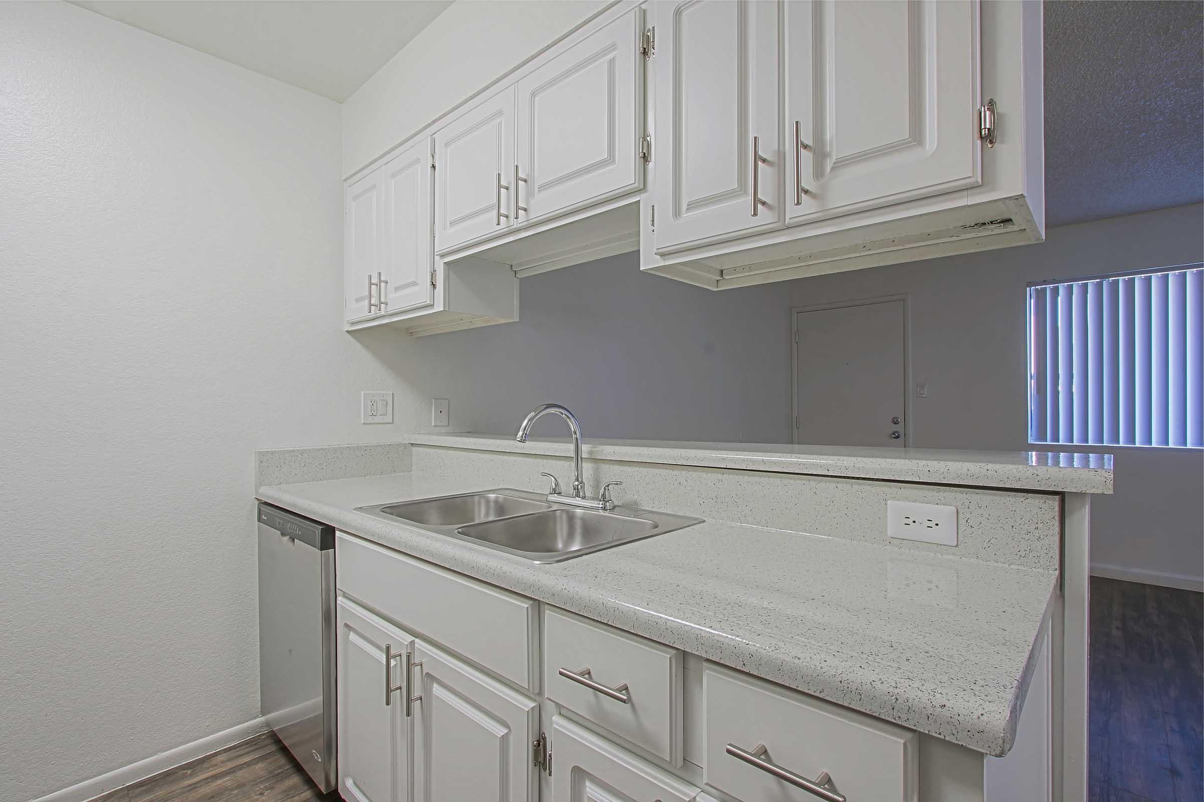 a kitchen with a sink and a mirror