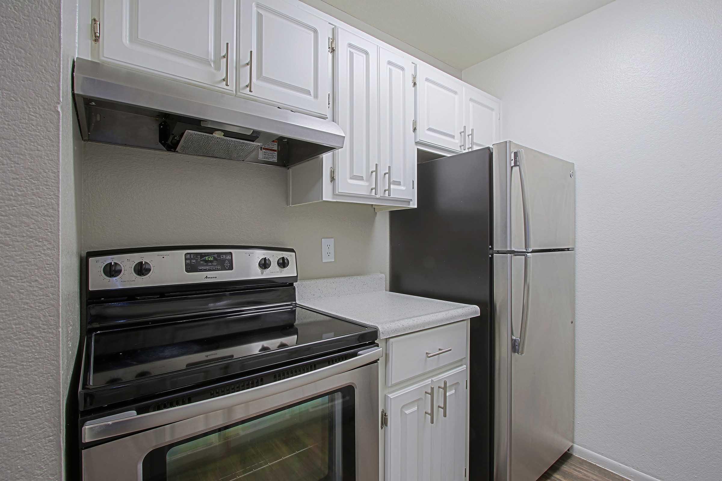 a stove top oven sitting inside of a kitchen