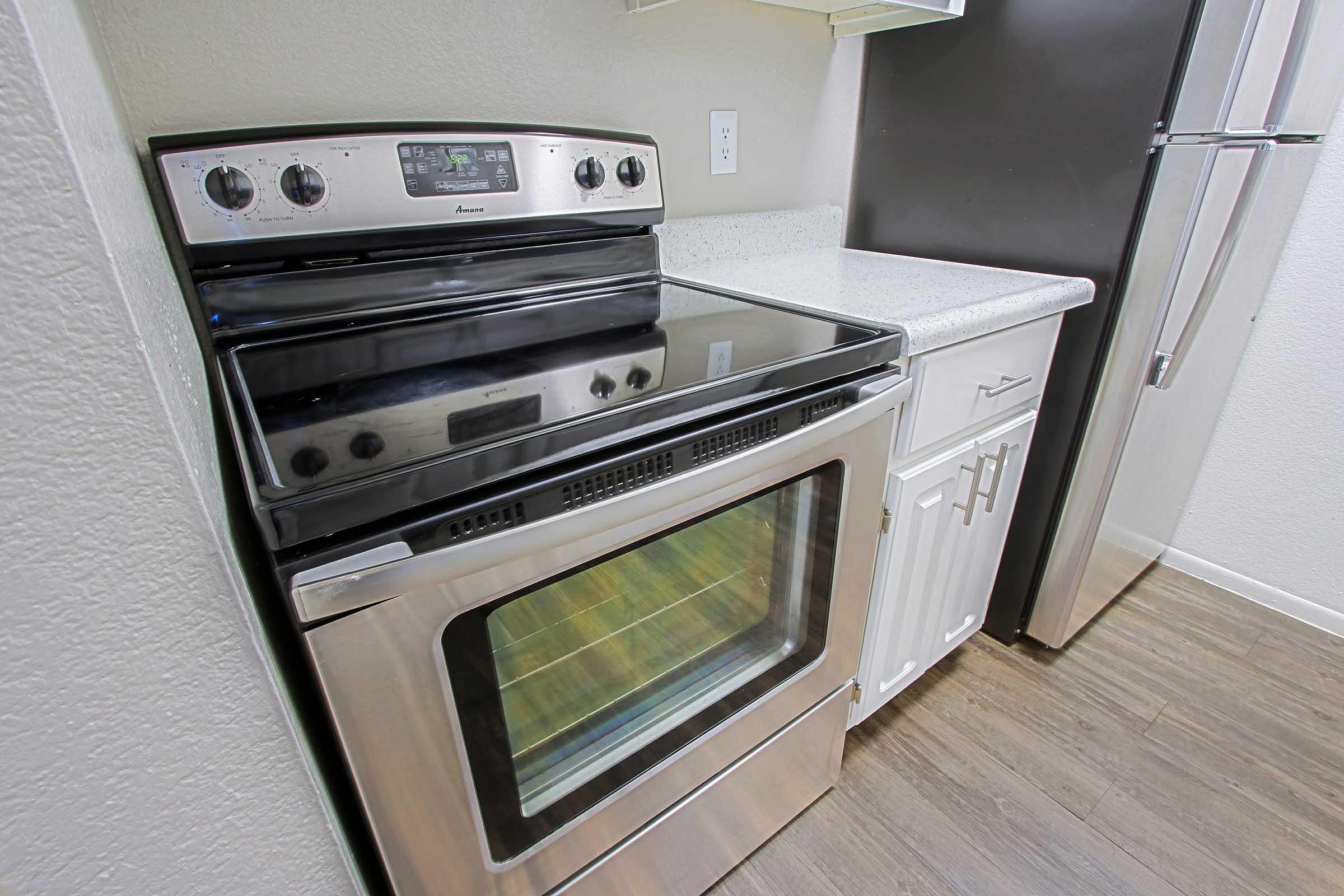 a stove top oven sitting inside of a kitchen