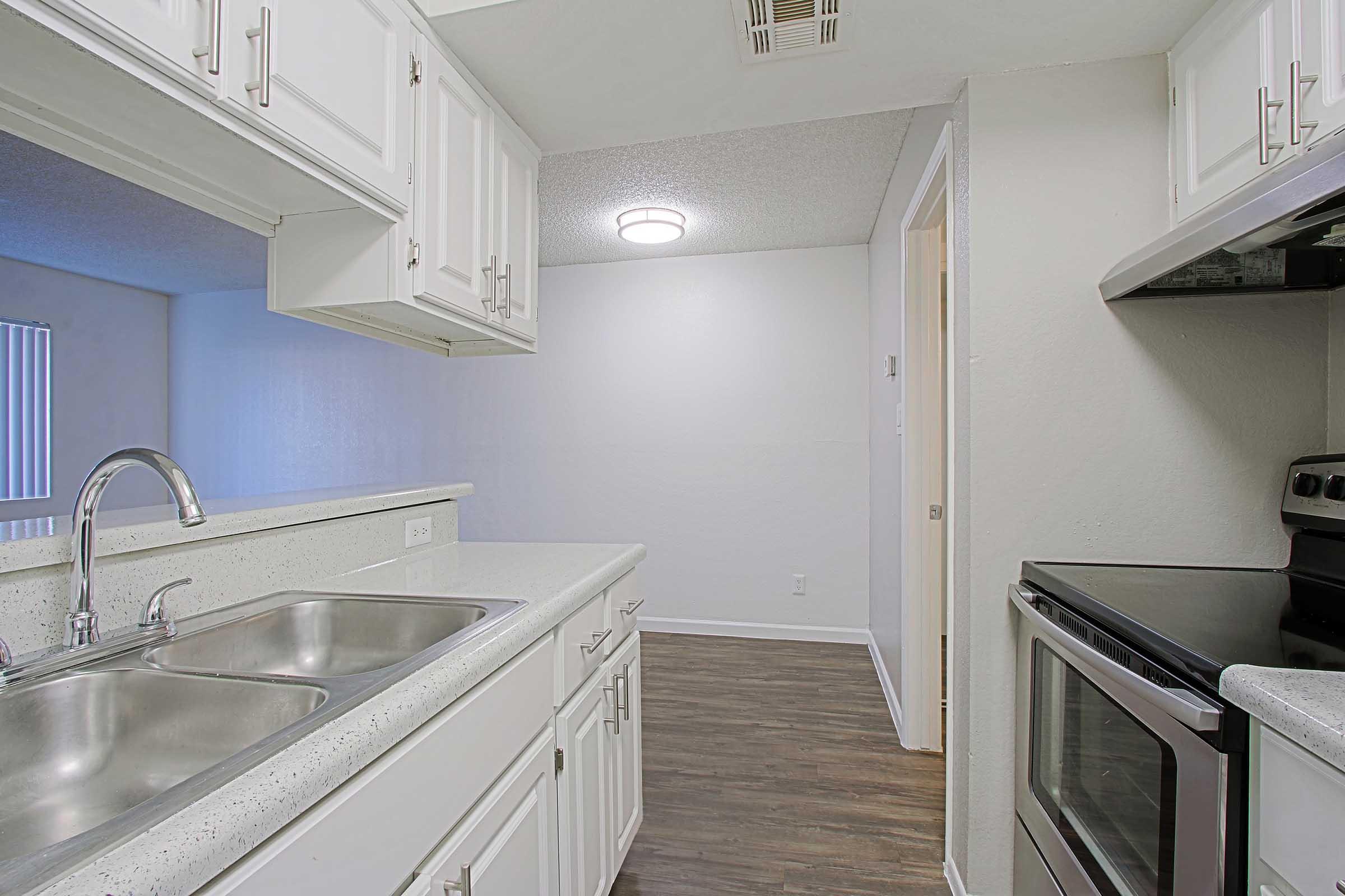 a stove top oven sitting inside of a kitchen