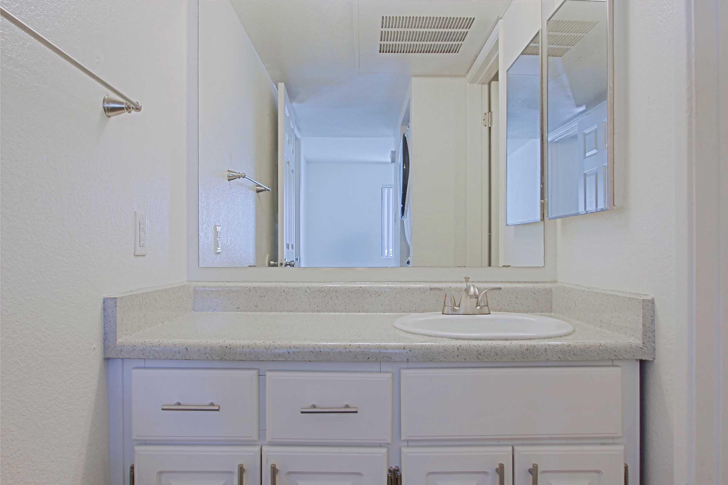 a kitchen with a sink and a mirror