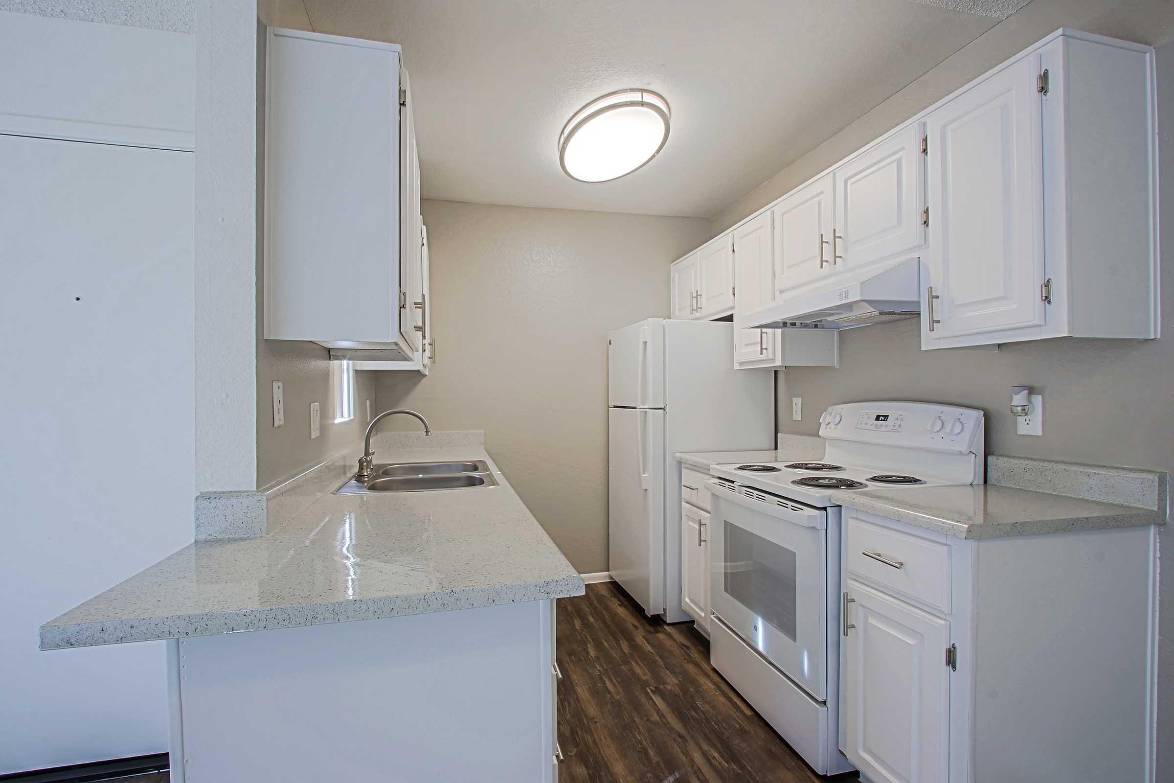 a kitchen with a stove and a refrigerator