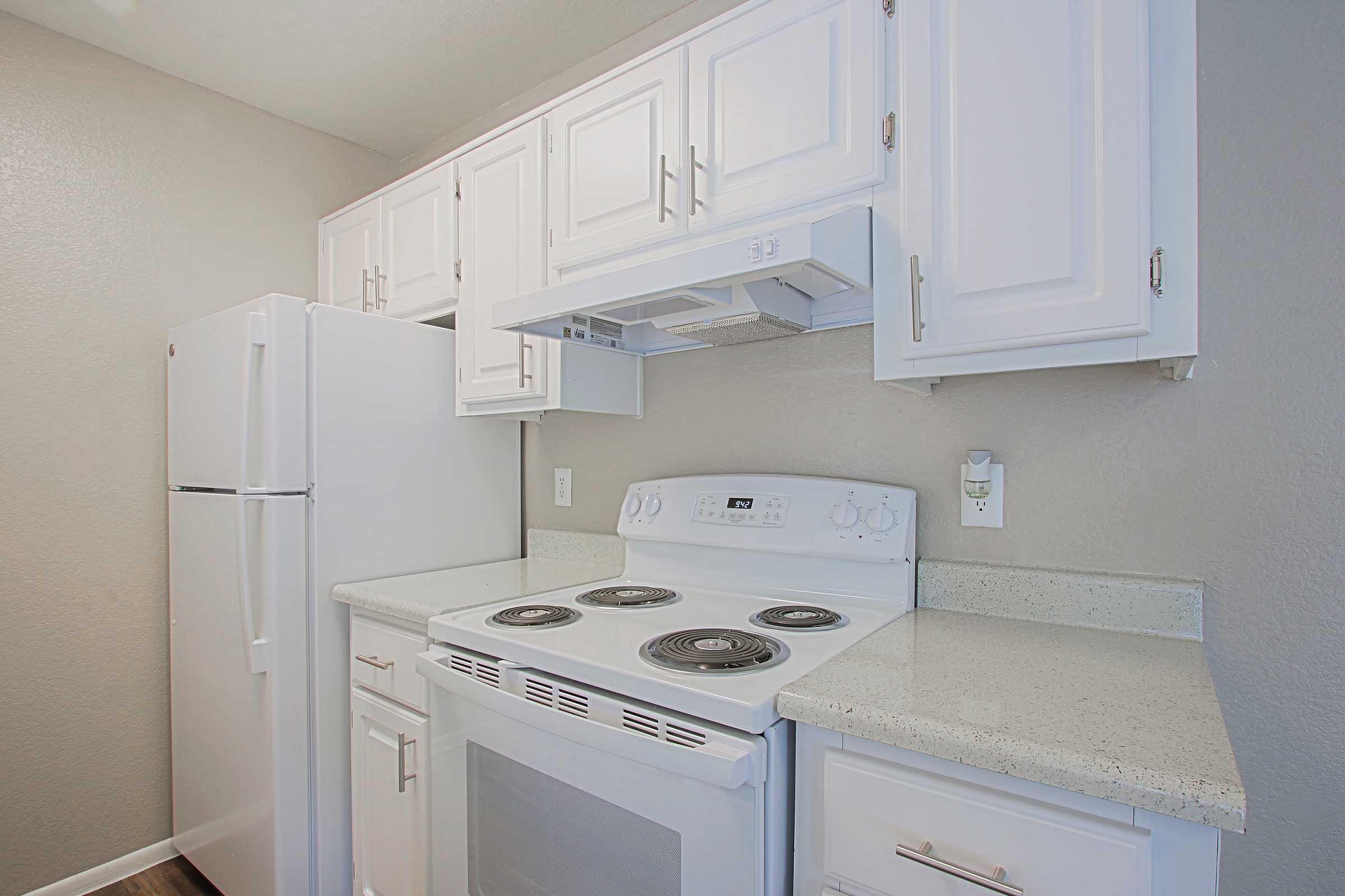 a kitchen with a stove top oven sitting inside of a refrigerator