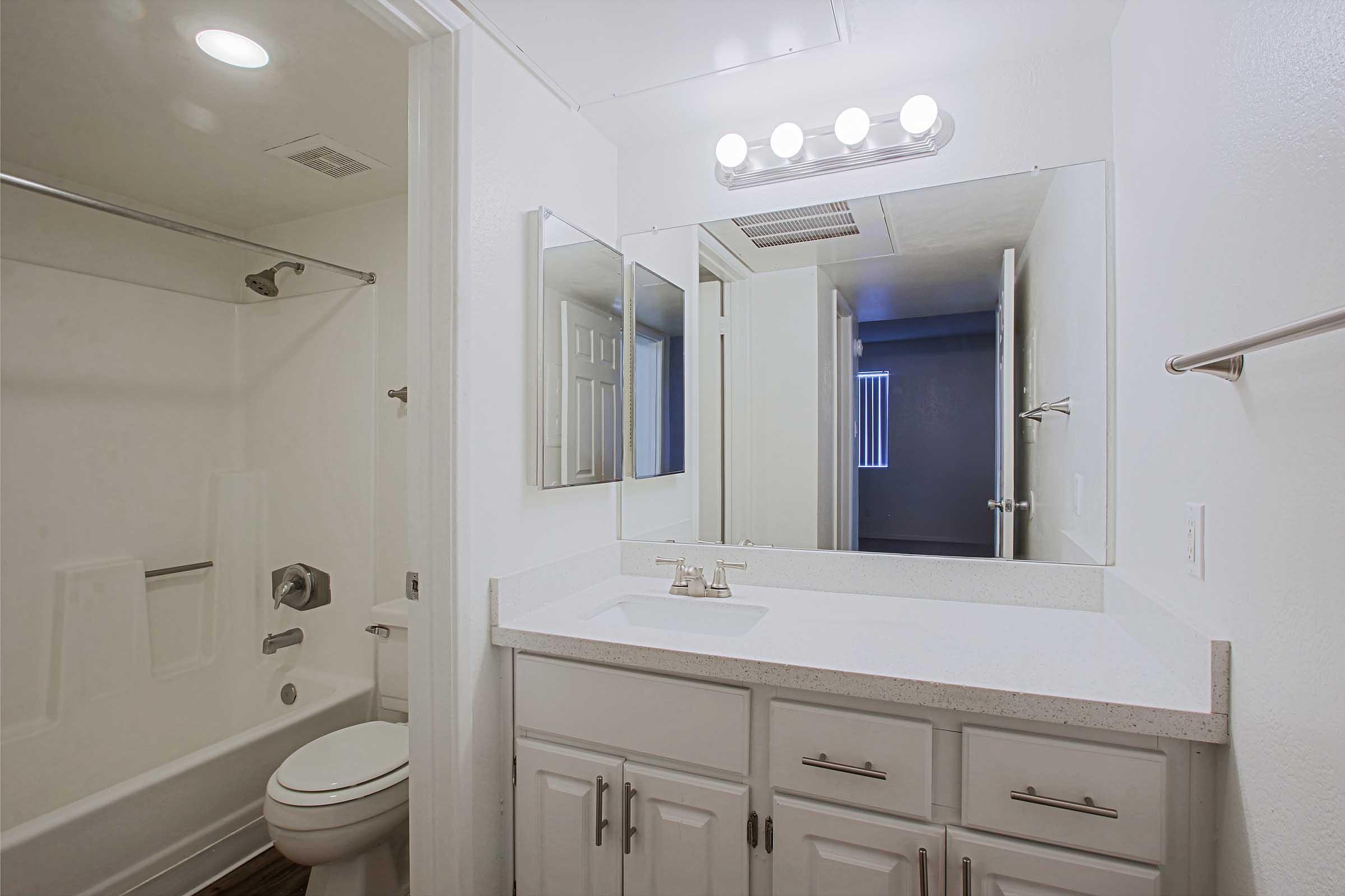 a room with a sink and a mirror