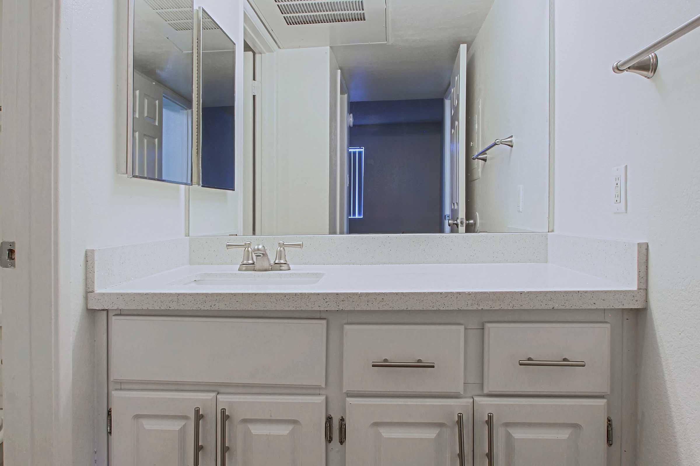 a kitchen with a sink and a mirror