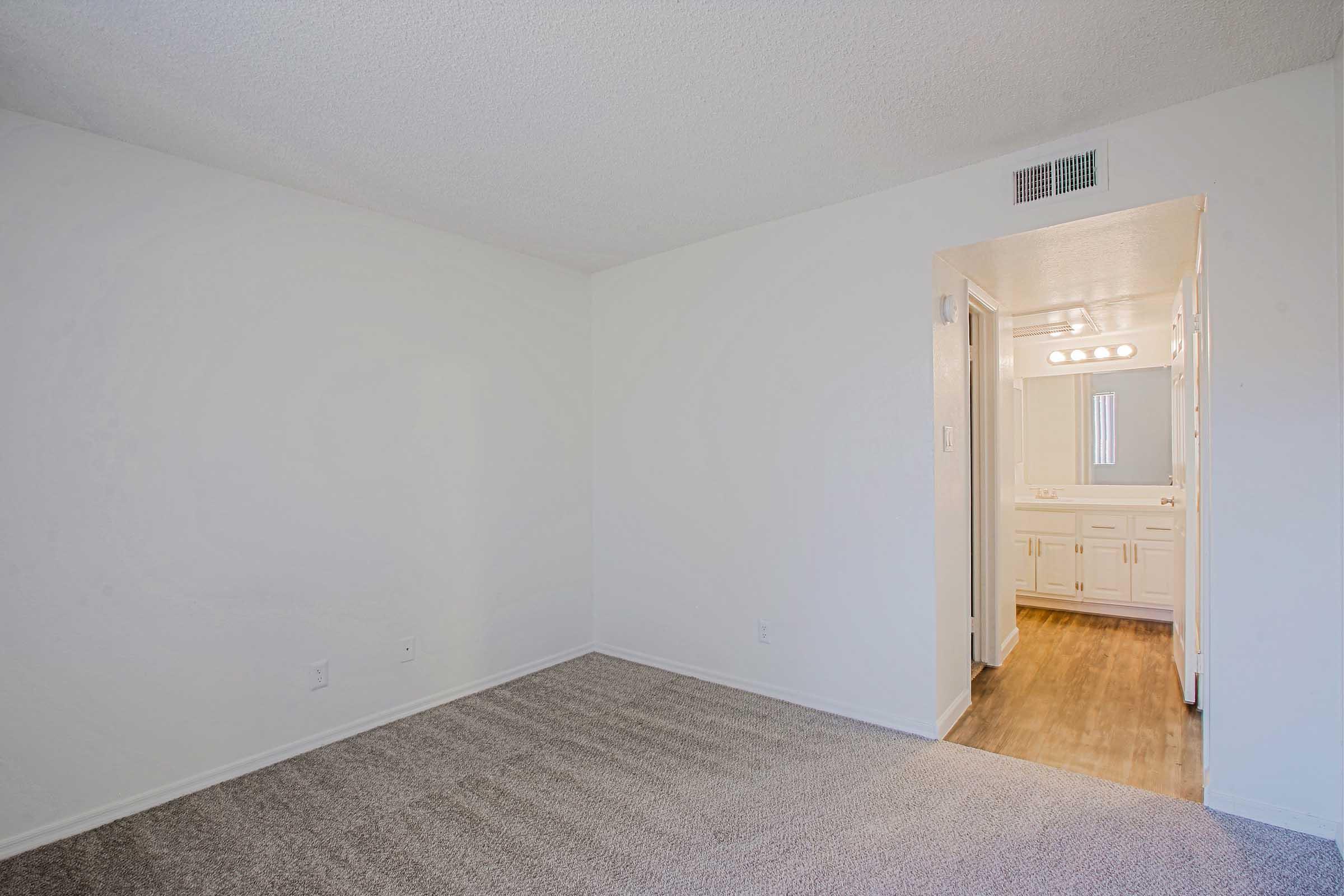 a bedroom with a wooden floor