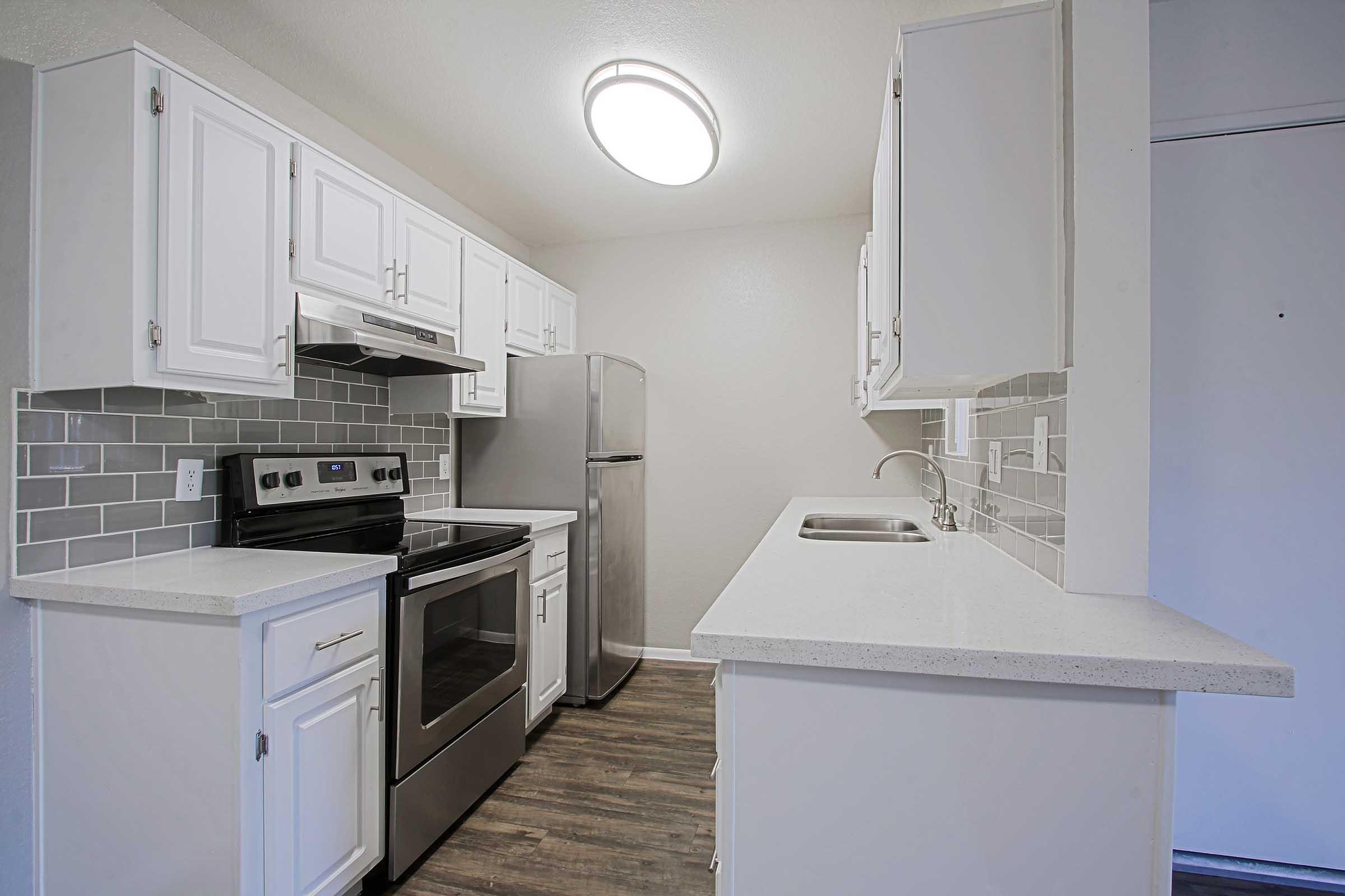 a kitchen with a stove sink and refrigerator